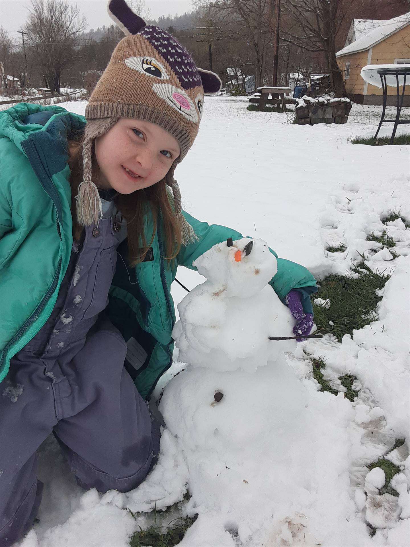 Student building snowman.