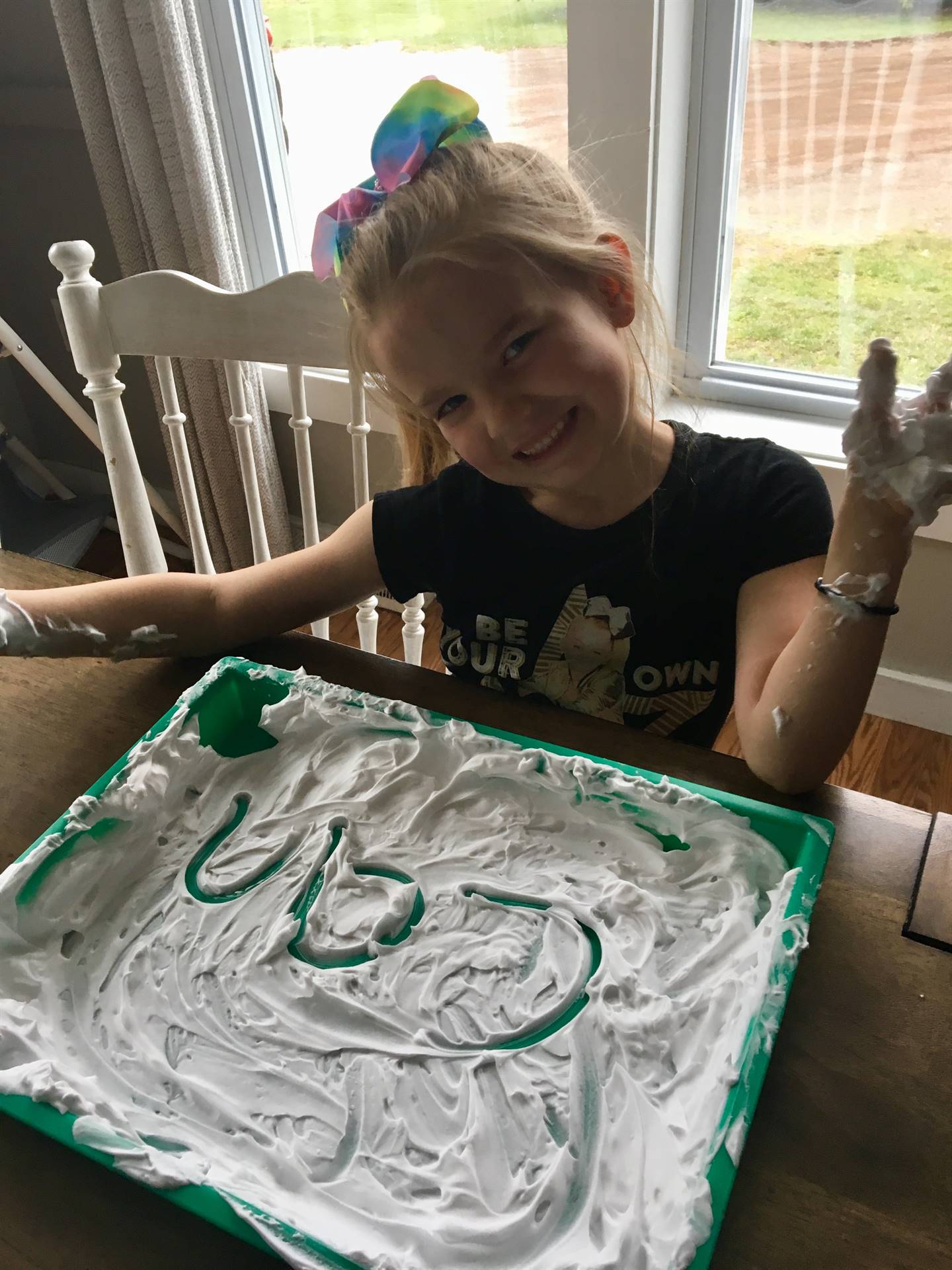 student with shaving cream tray.