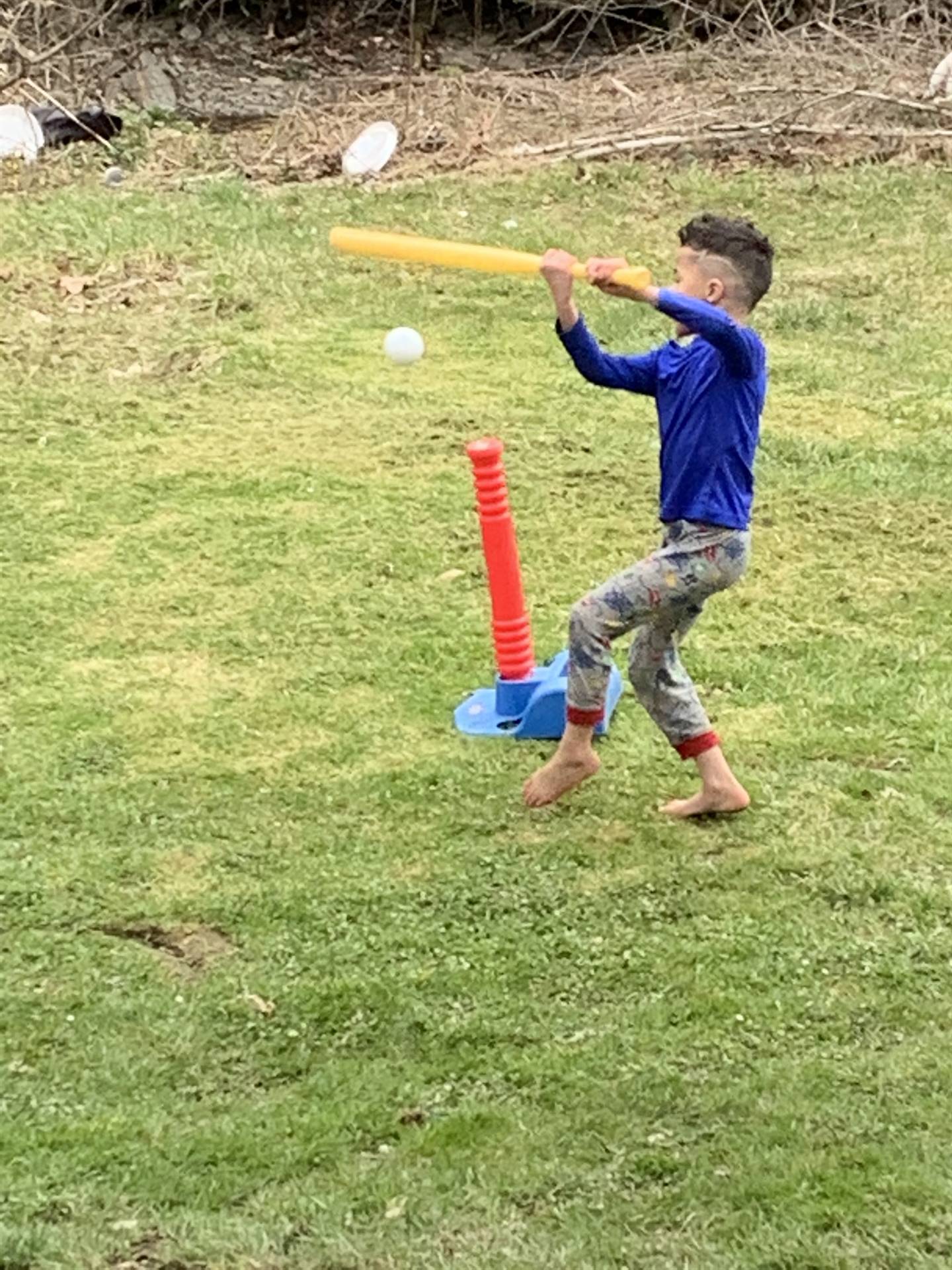 A boy bats a ball!