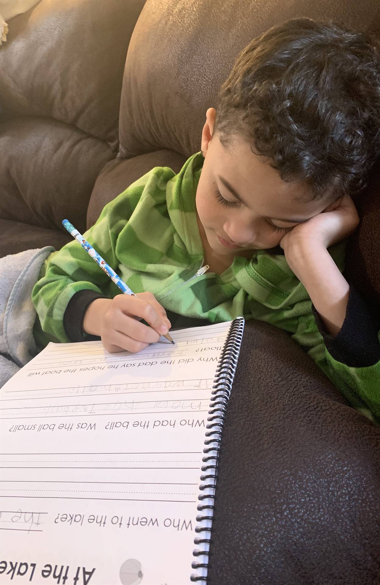 A boy doing writing.