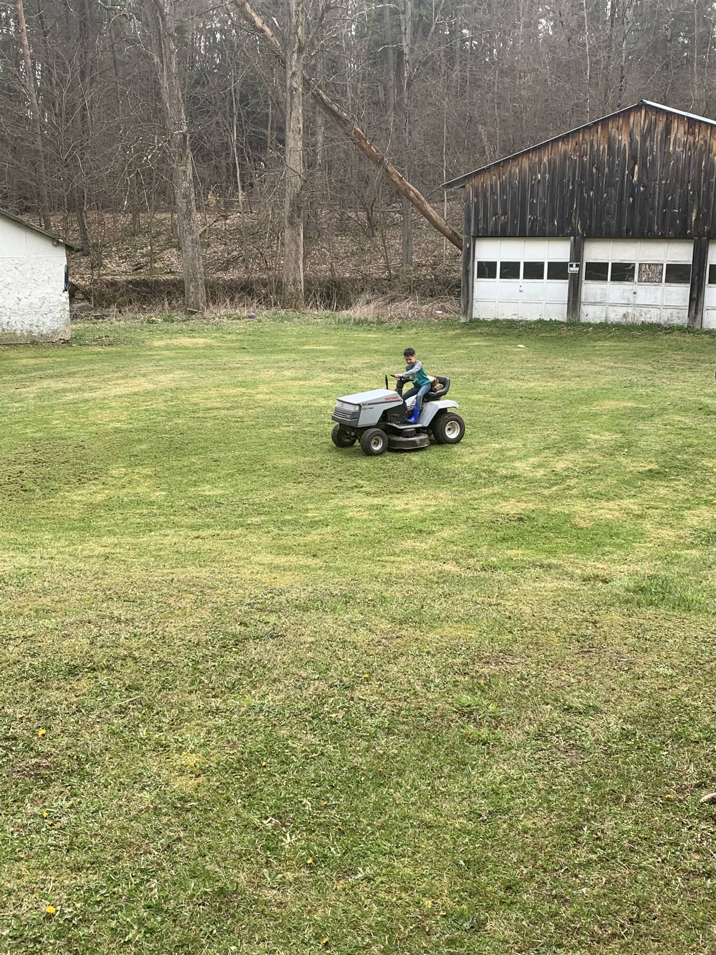 A boy drives his tractor.
