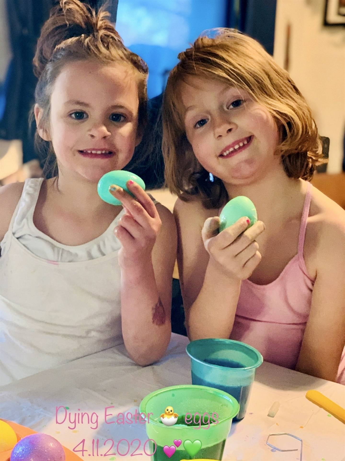 2 kids coloring easter eggs.