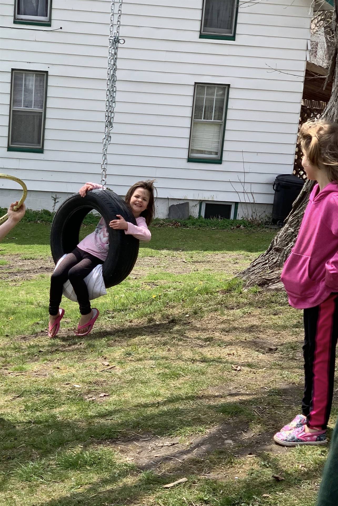 A child on a tire swing.