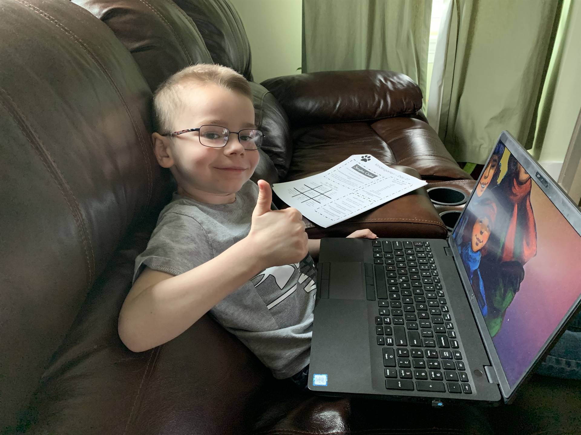 A boy shows off his work