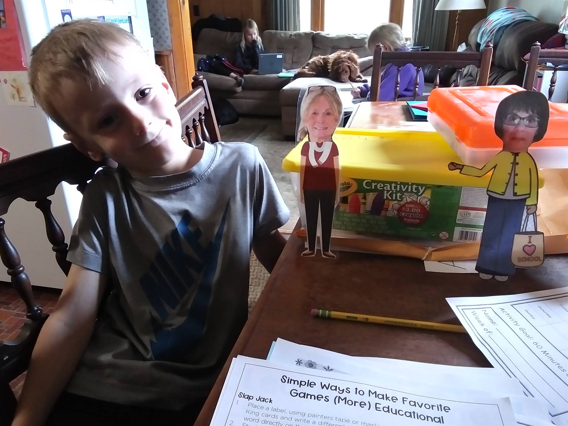 A student with paper doll teachers.