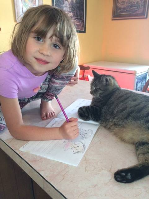 A student and her cat assistant.