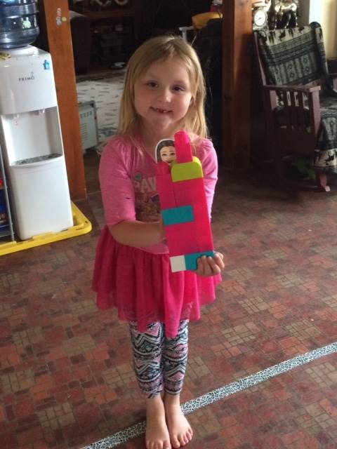 a student with her paper doll teacher.