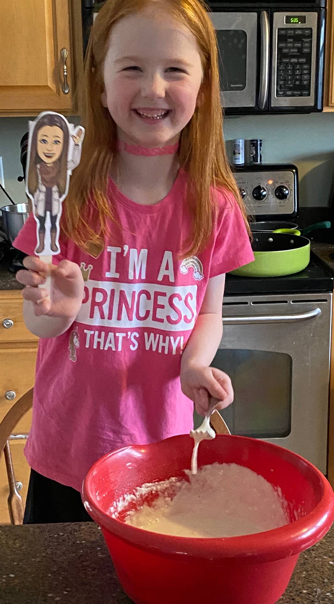 student with paper doll teacher making pancakes.