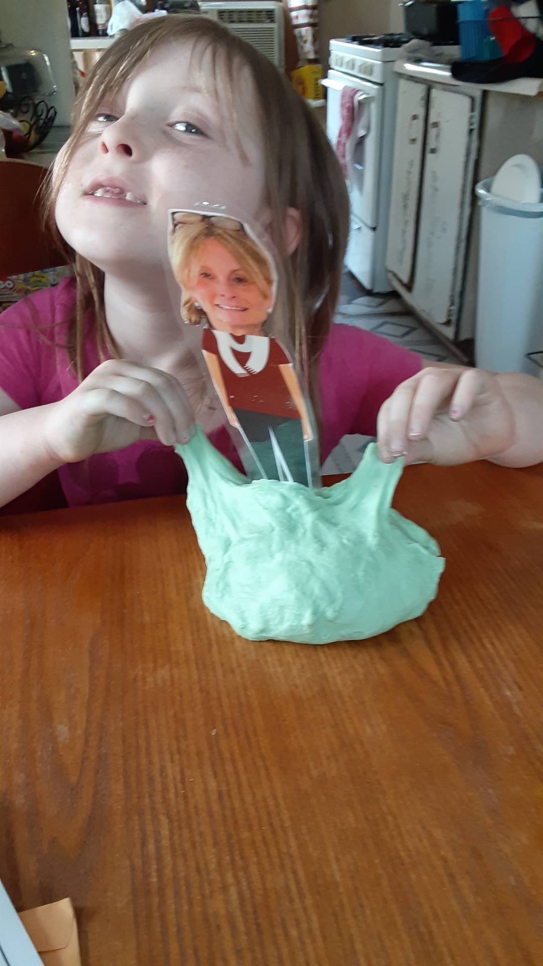 A student makes slime with their paper doll teacher.
