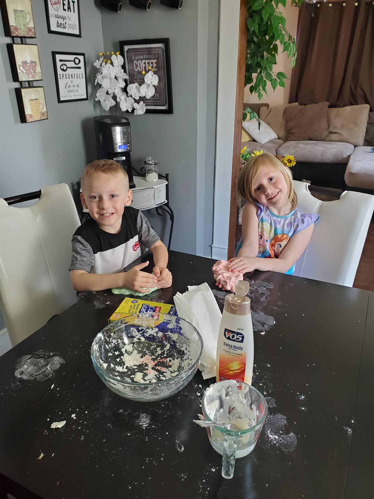 A student and sibling doing a messy project!