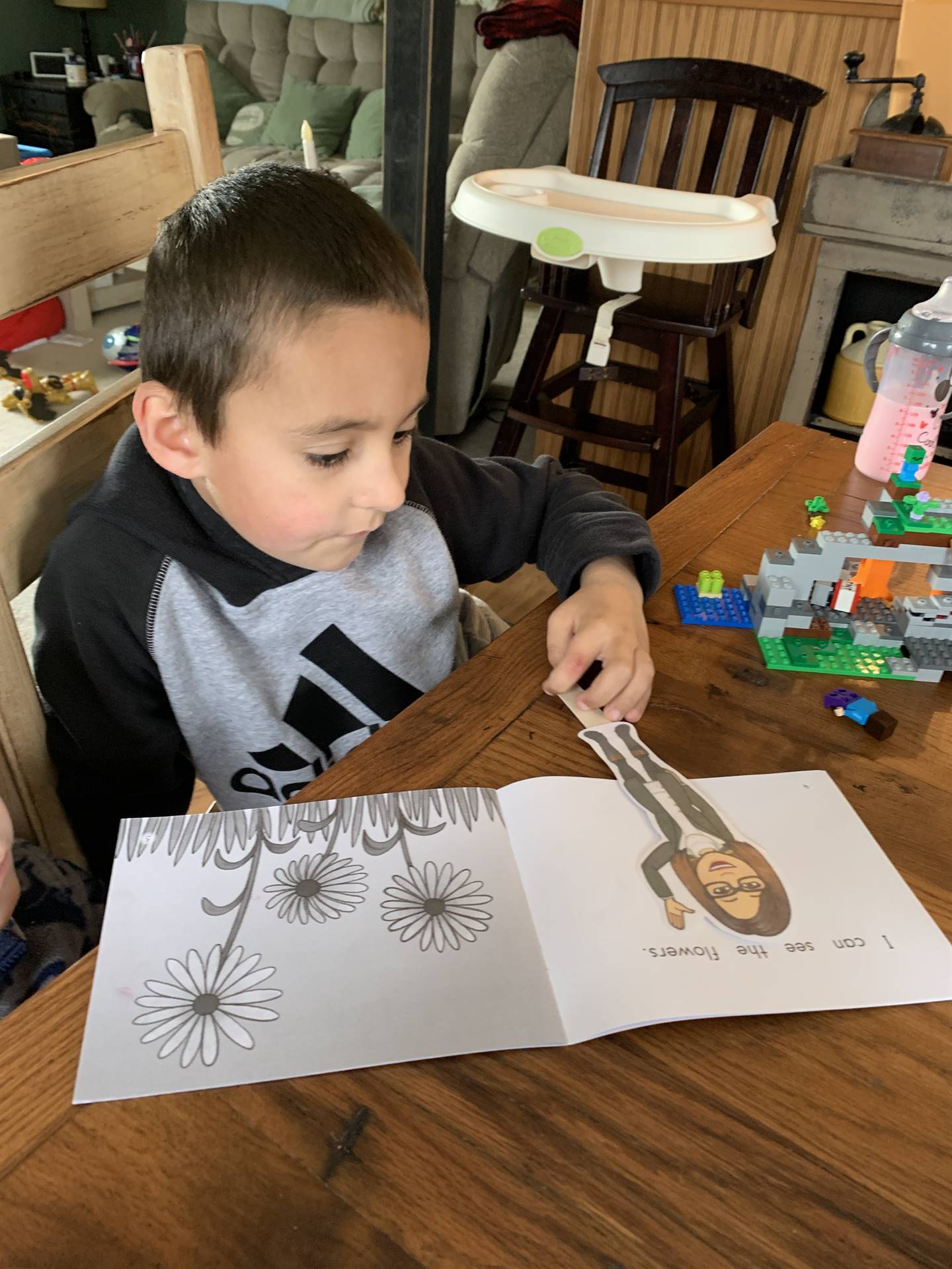 student with paper doll teacher doing art.