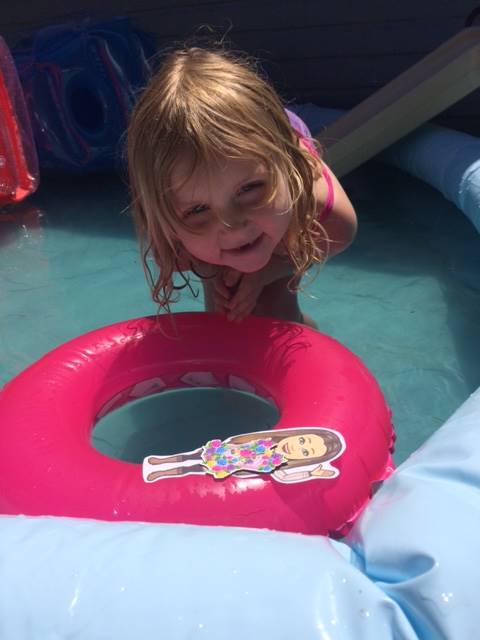 Student swimming with her teacher.