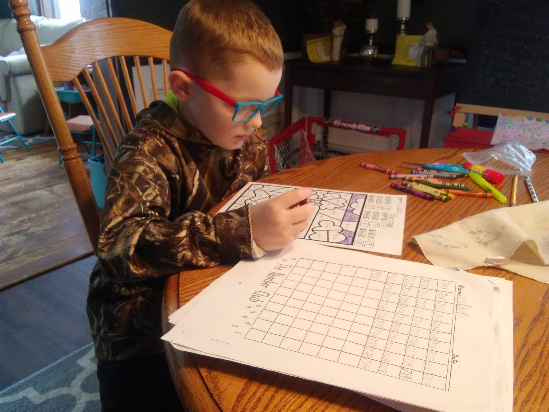 student working in glasses.