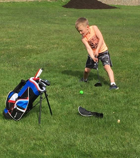 boy playing golf.