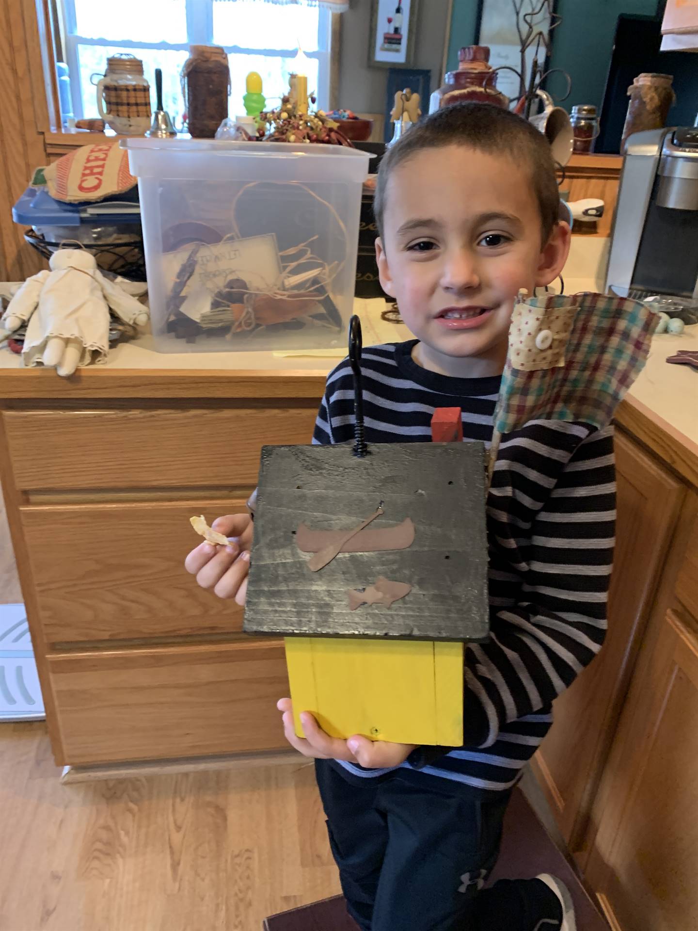 boy with finished painted birdhouse.
