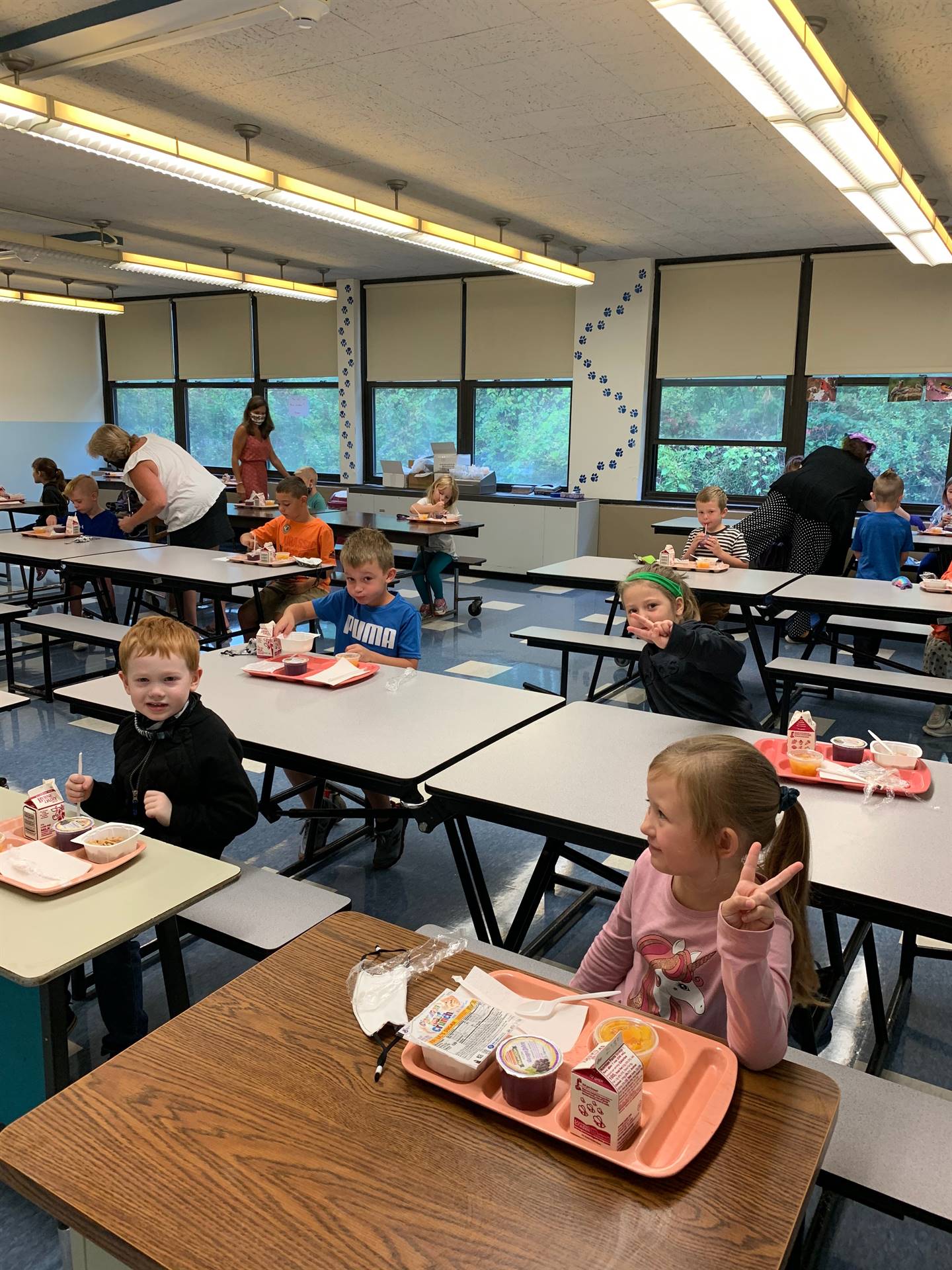 students give the "peace sign" with fingers