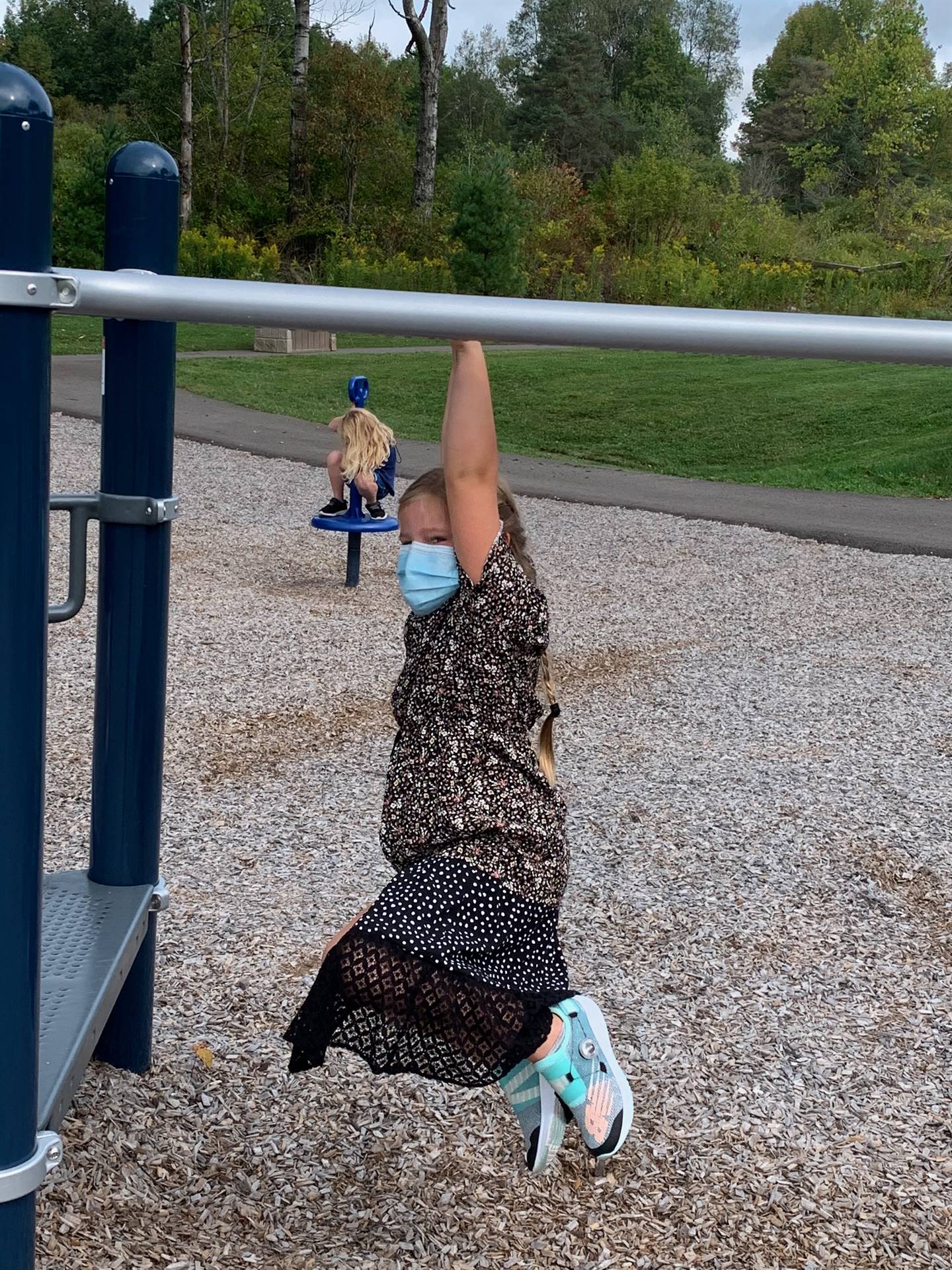 student hanging on monkey bars!