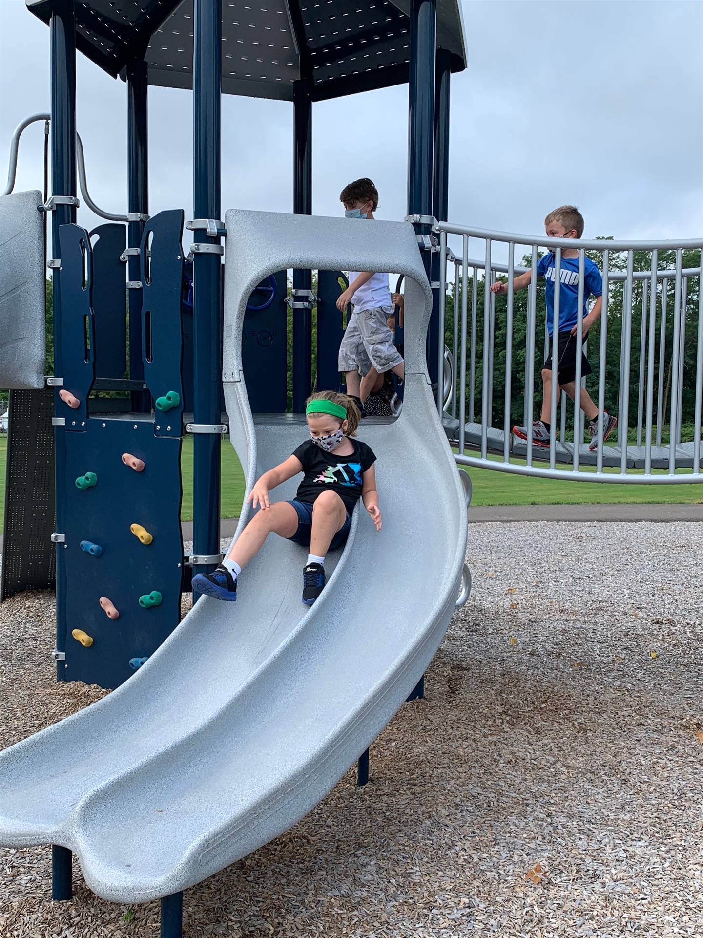 student sliding down slide.