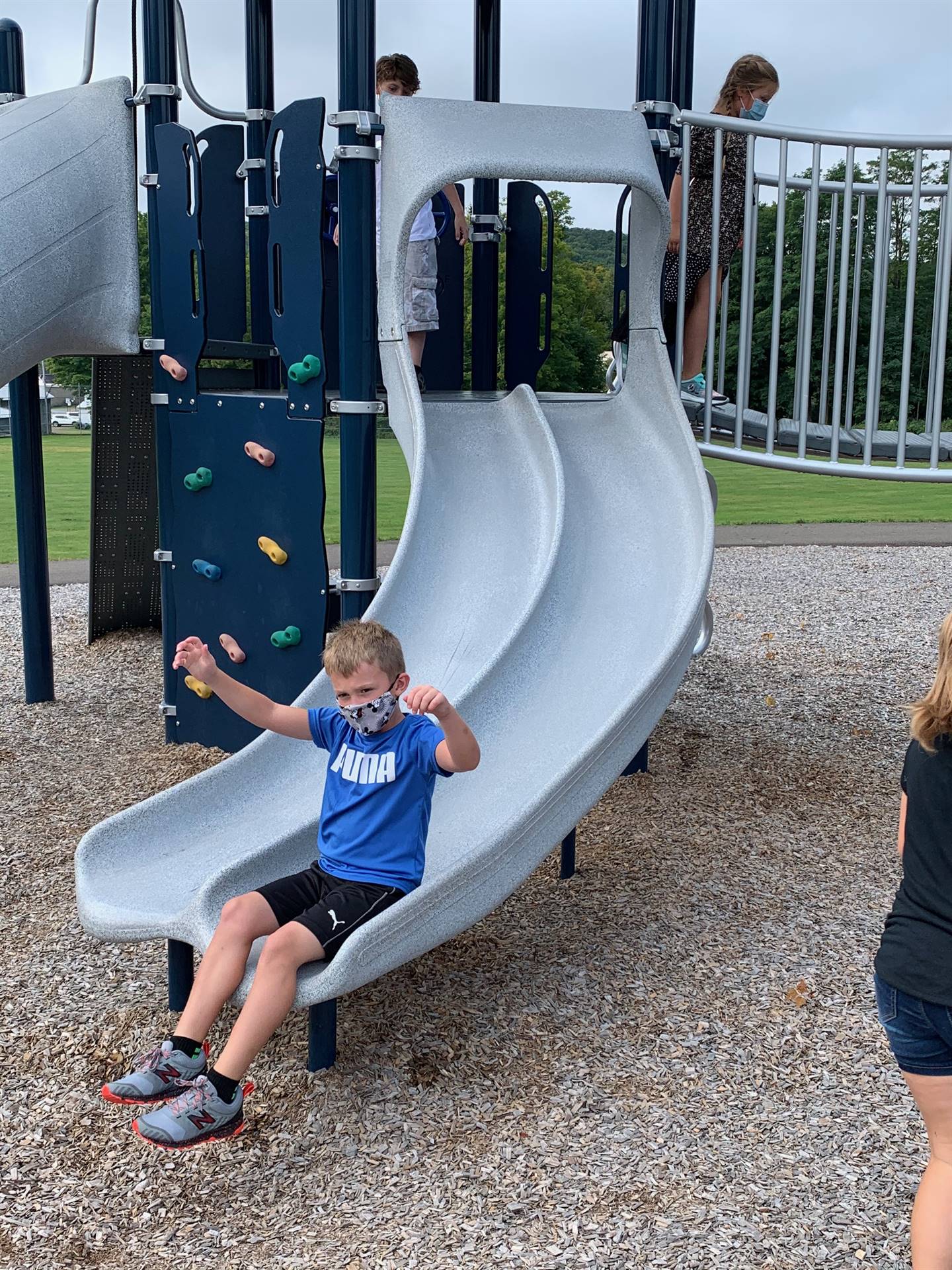 student sliding down slide.