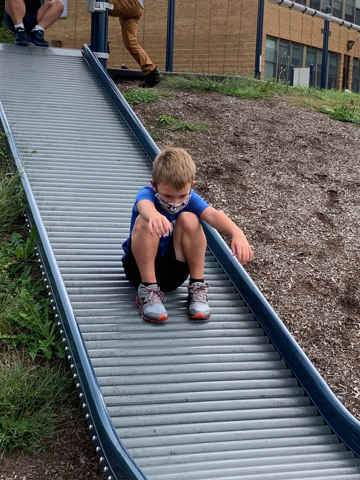 student sliding down slide.