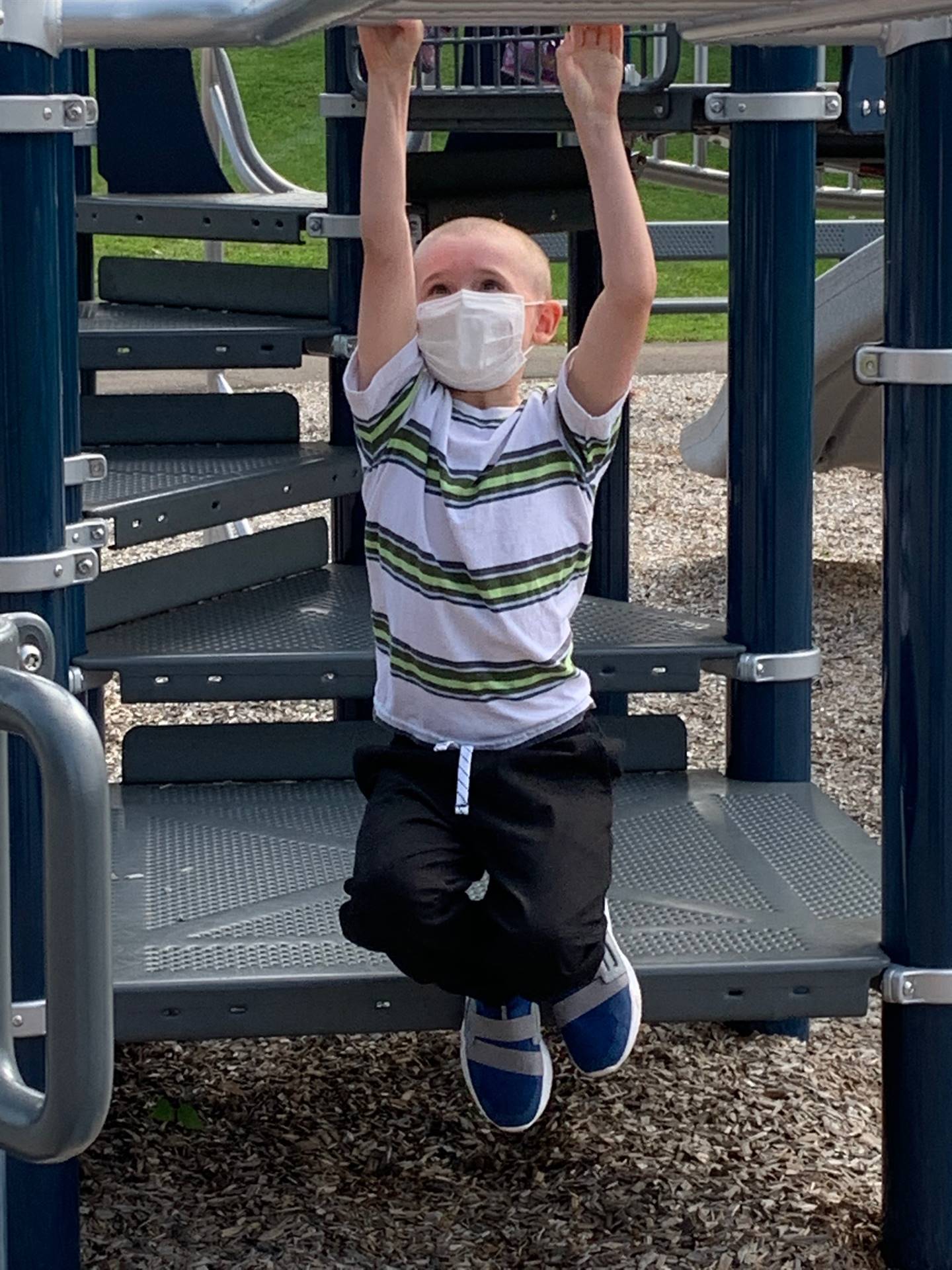 Student hanging on monkey bars