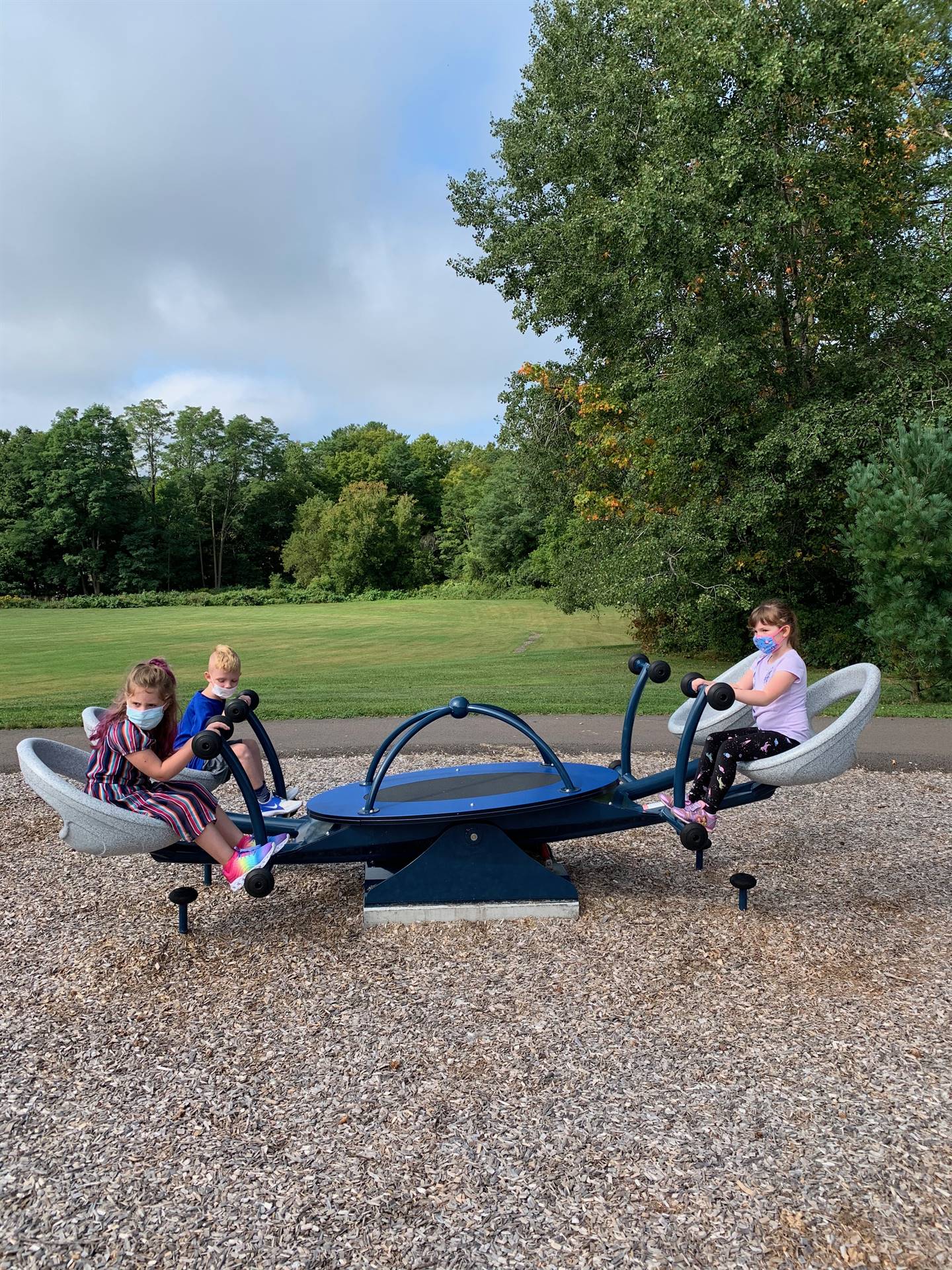 3students on rocking toy.