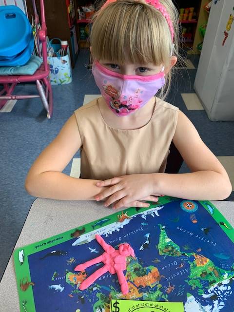 a child with her play do friend. made out of pink play do.