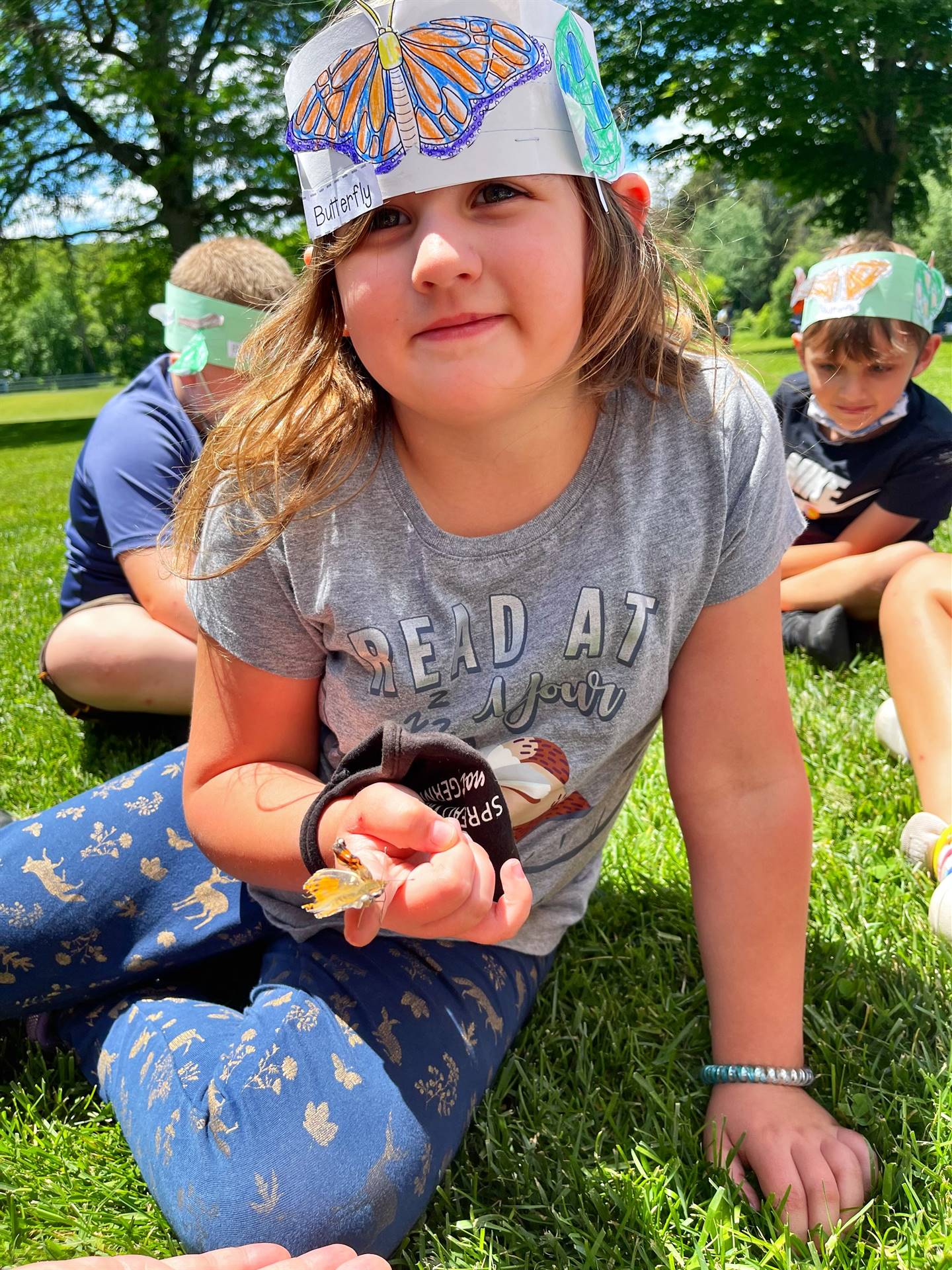 a student holds a butterfly