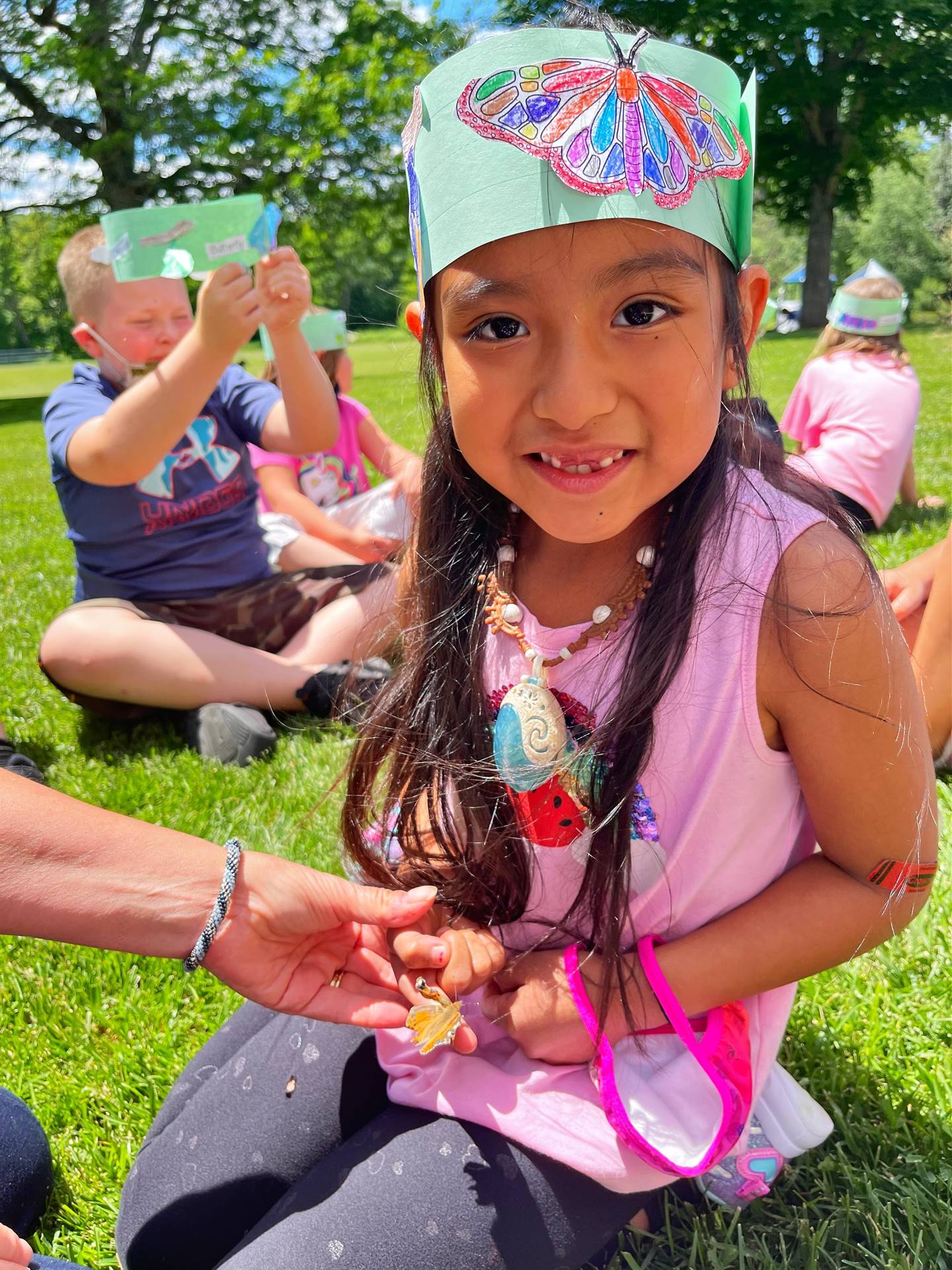 a student holds a butterfly