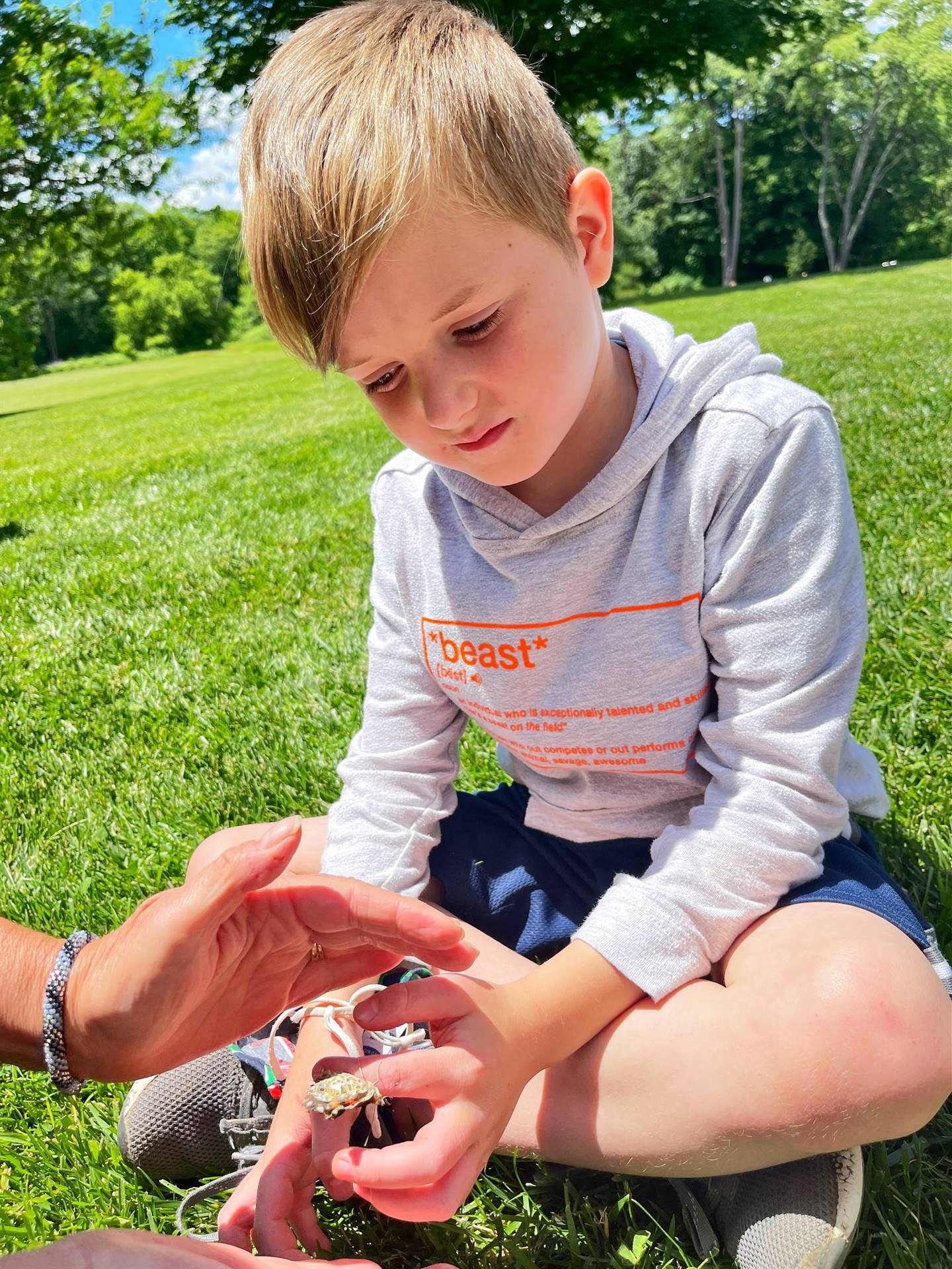 a student holds a butterfly