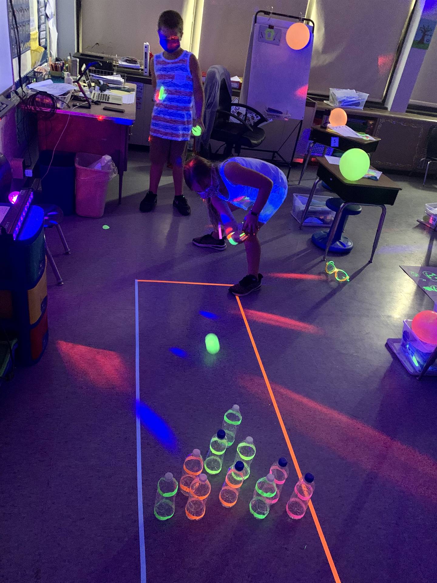 students playing glow up bowling
