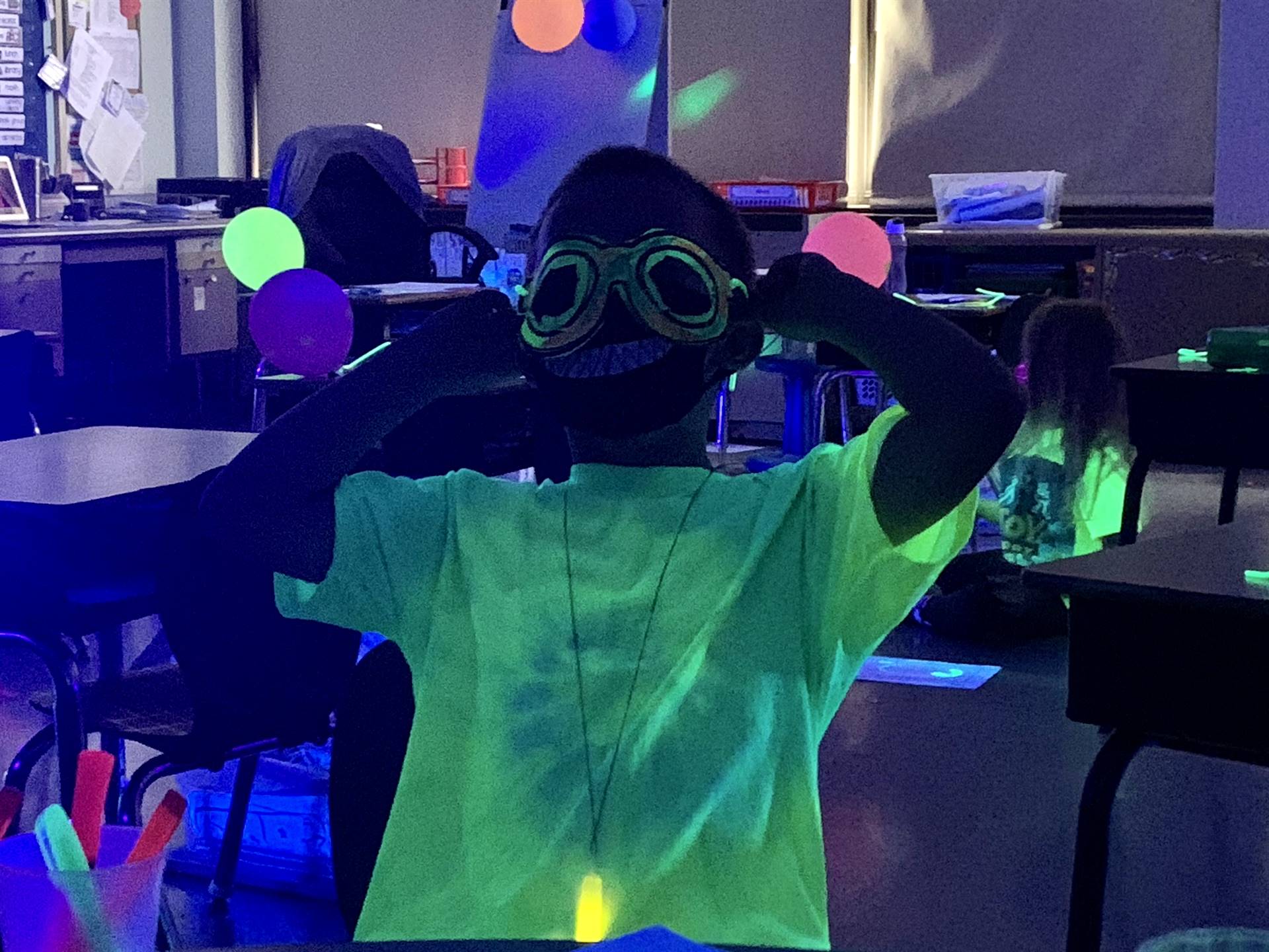 a student in glow up glasses.