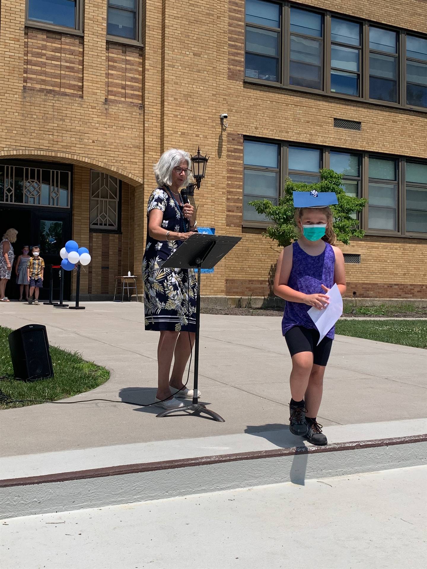 Principal hands certificate to student