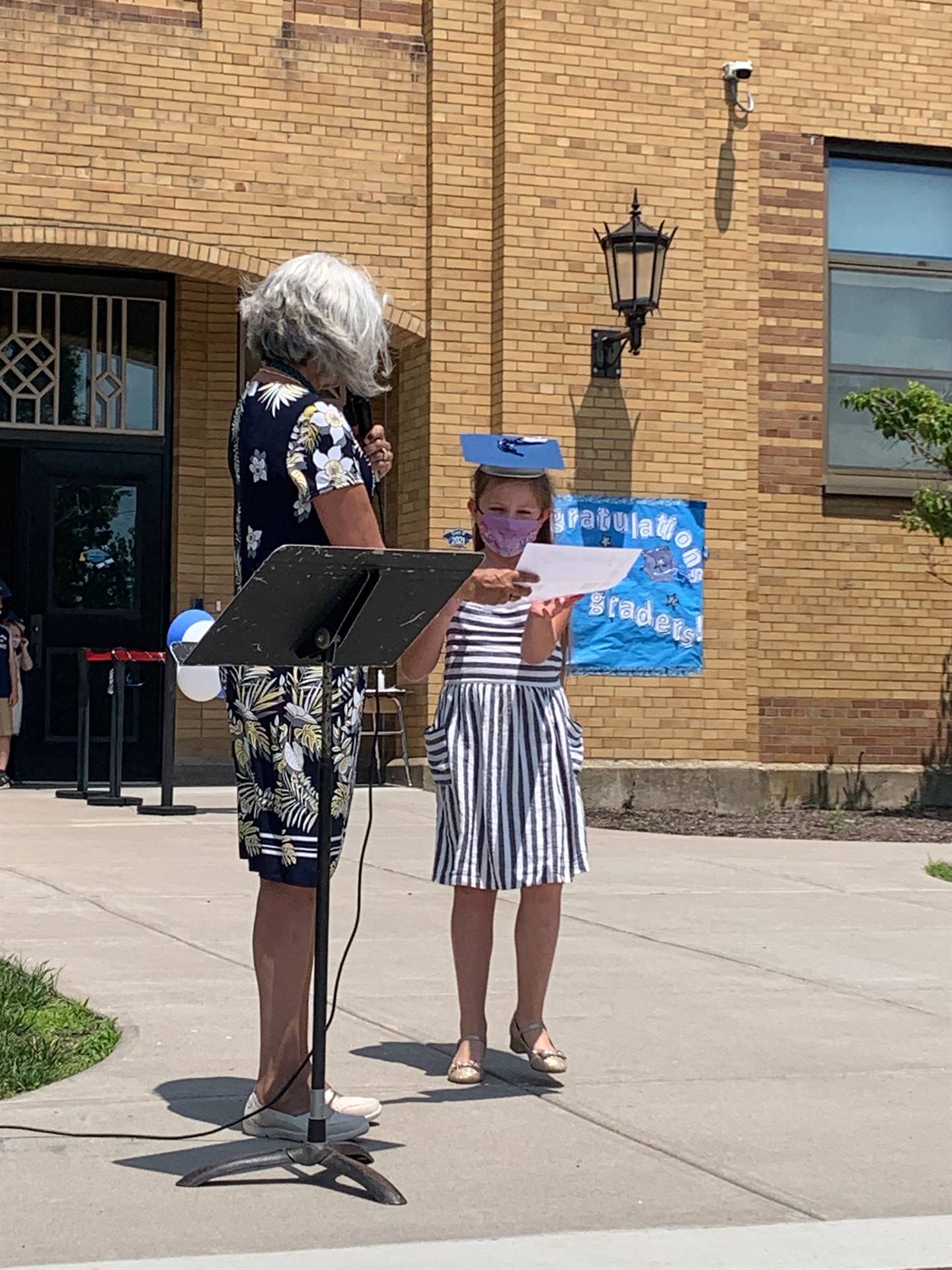 Principal hands certificate to student