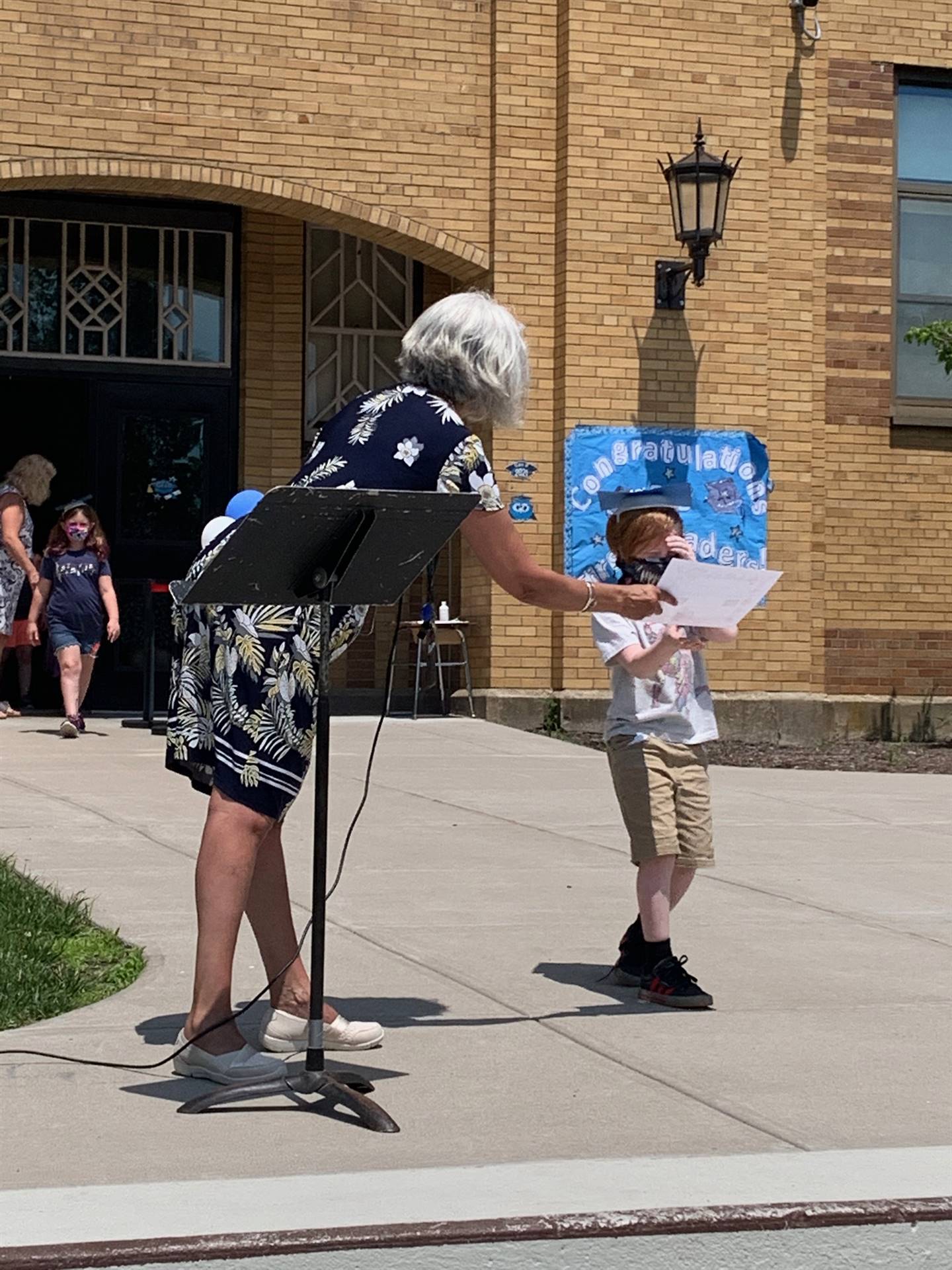 Principal hands certificate to student