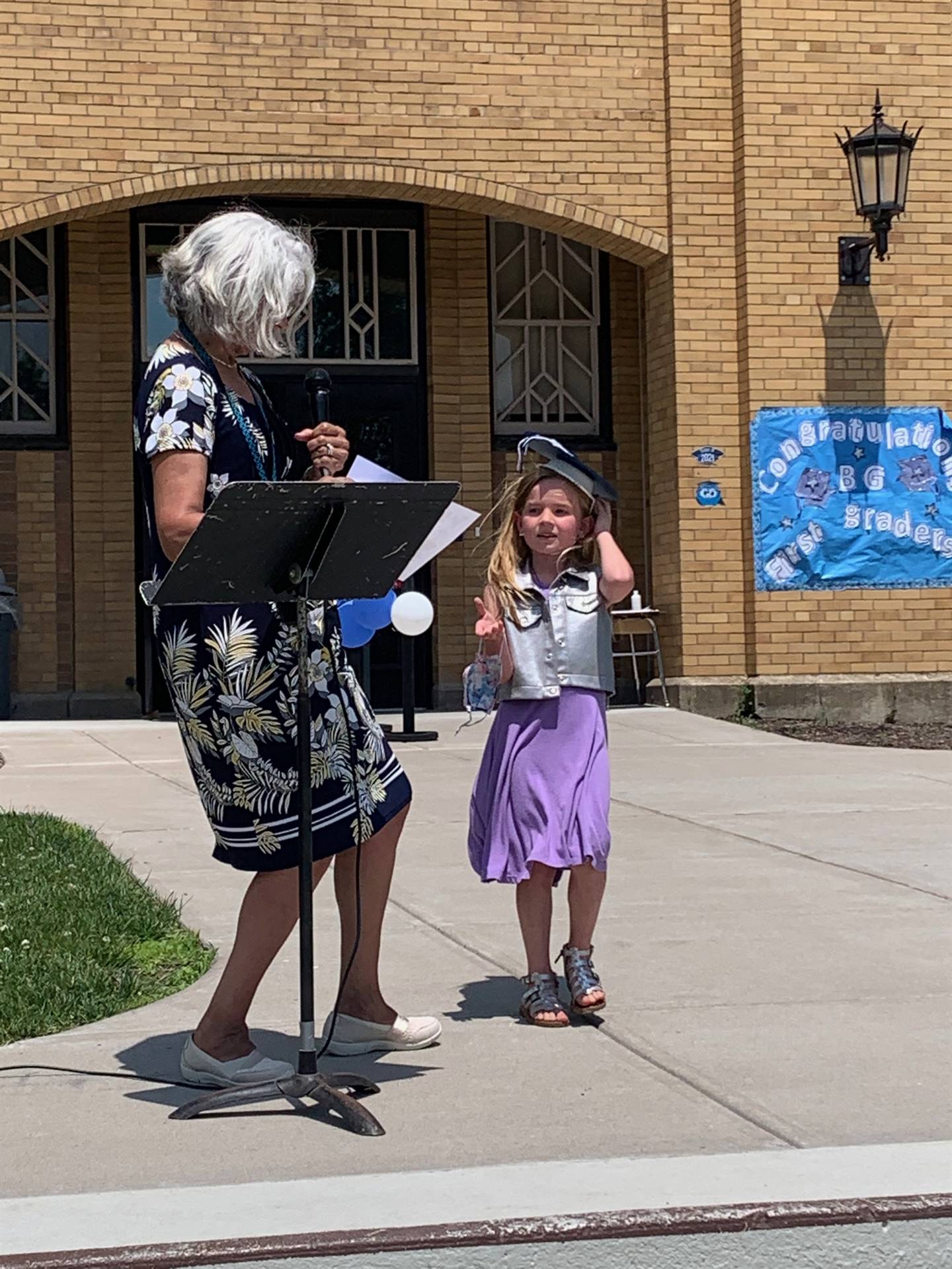 Principal hands certificate to student