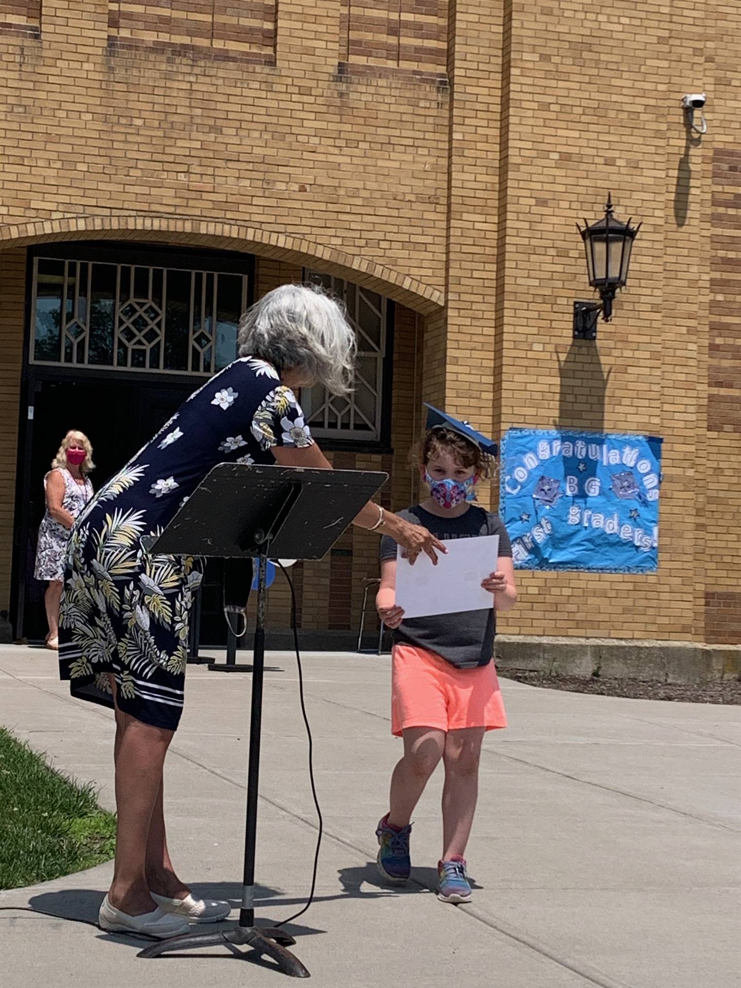 Principal hands certificate to student