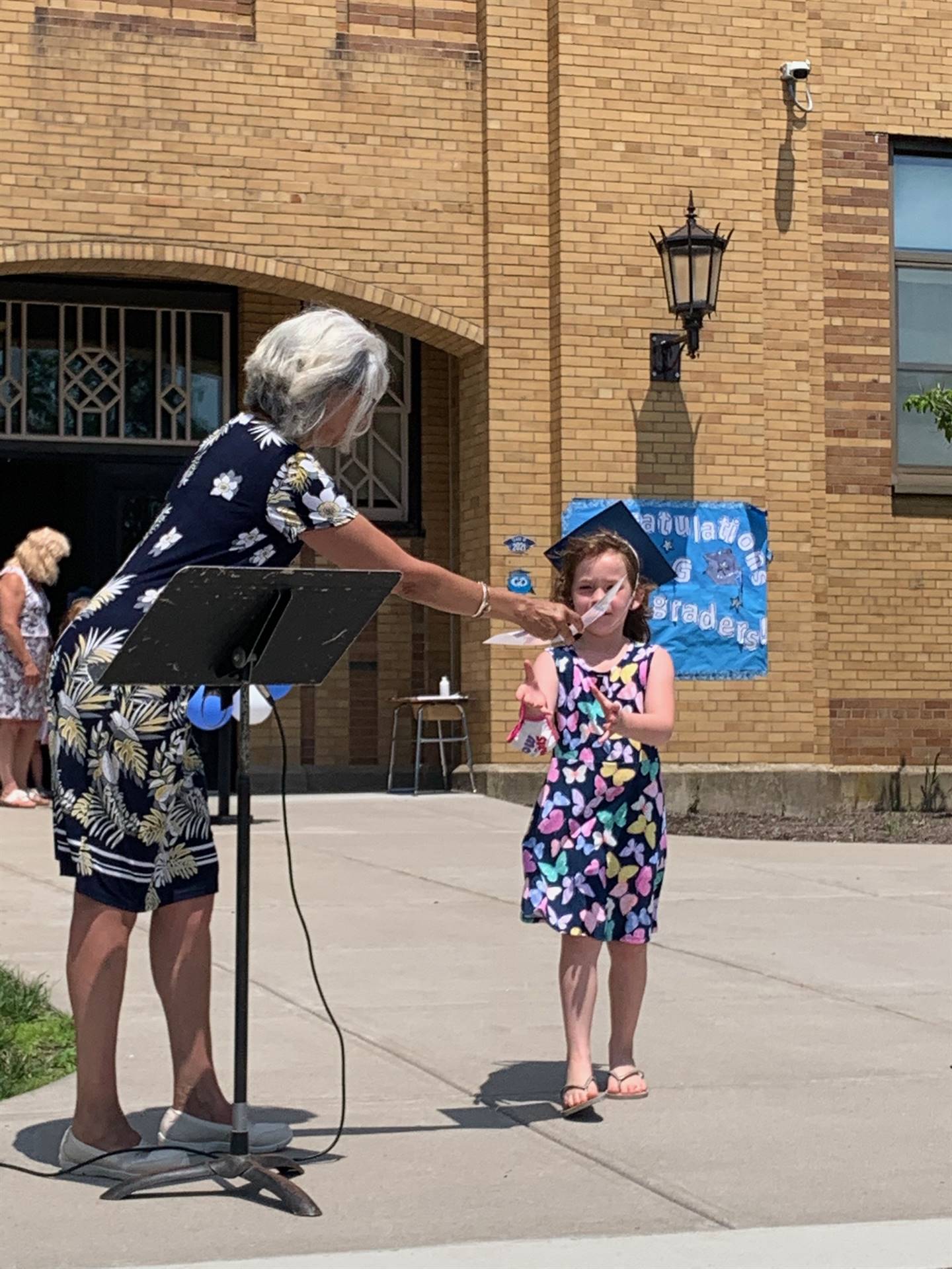 Principal hands certificate to student