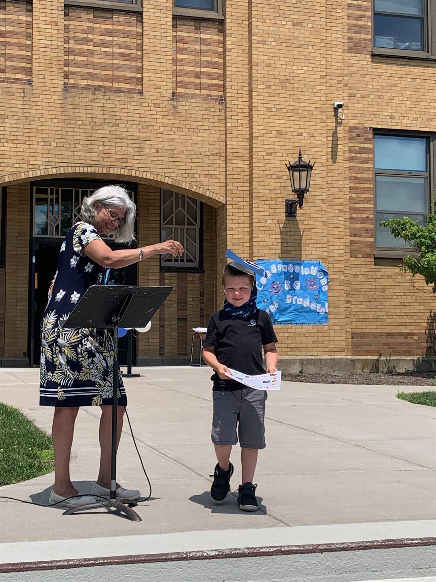 Principal hands certificate to student