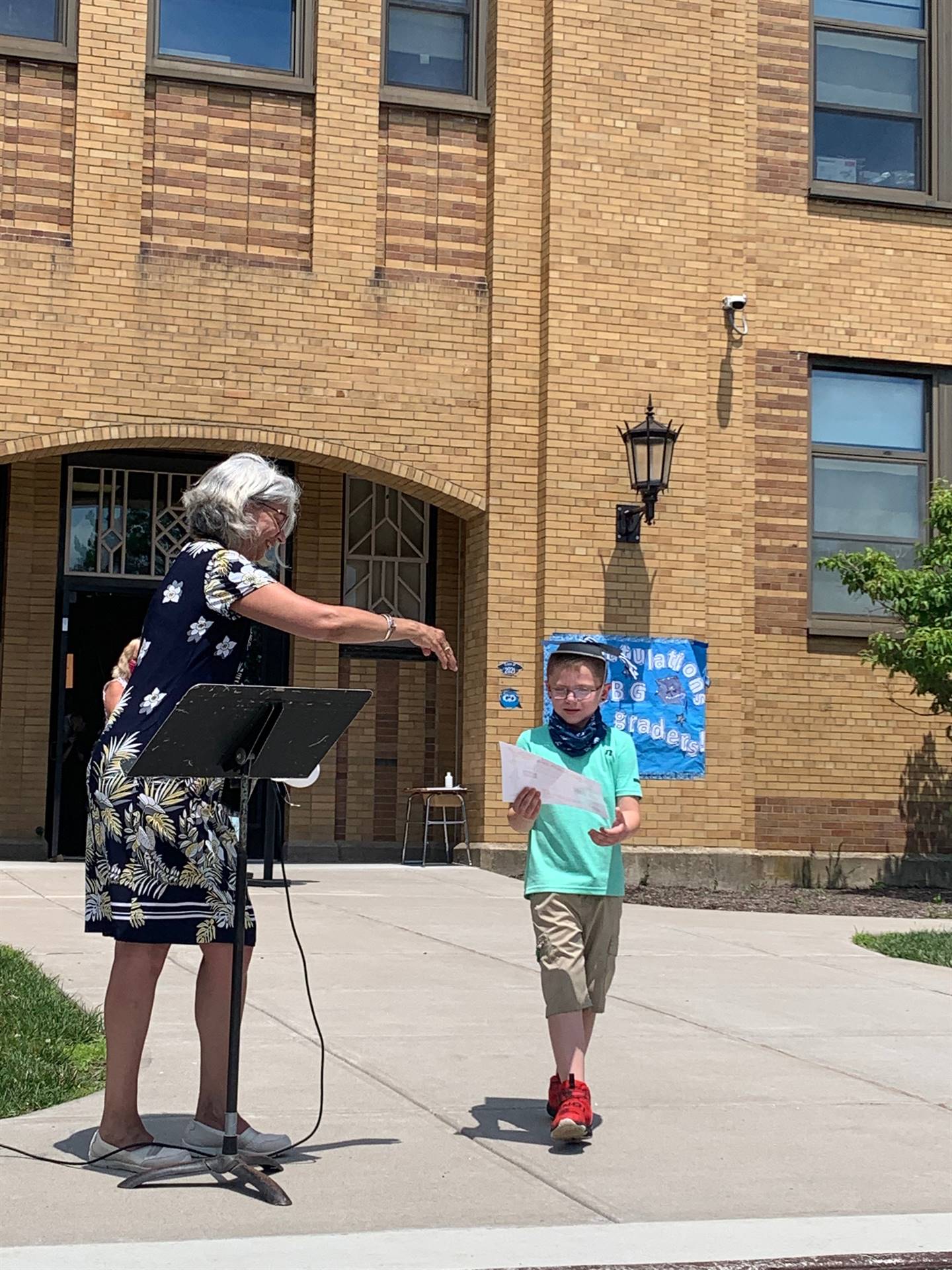 Principal hands certificate to student