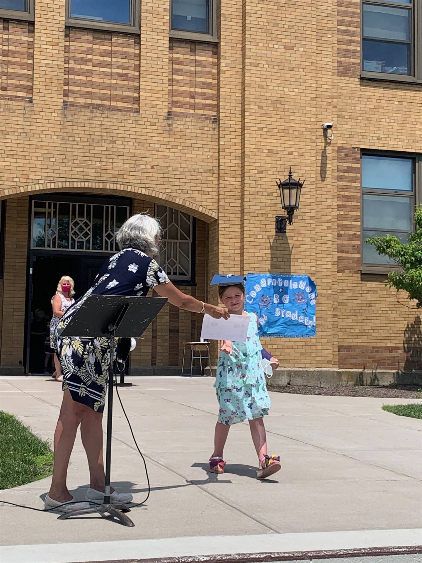 Principal hands certificate to student