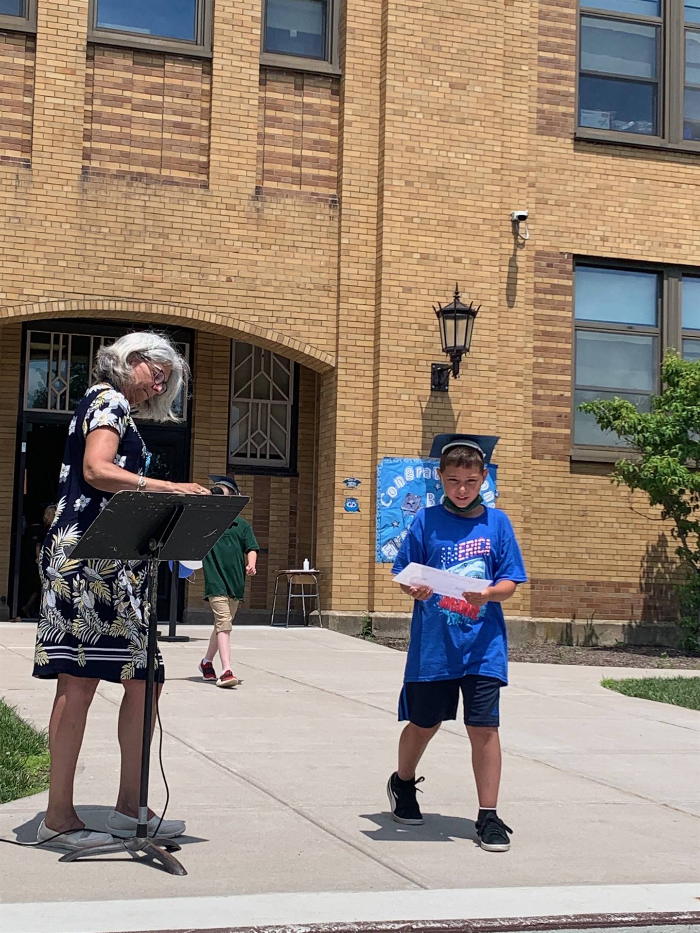 Principal hands certificate to student