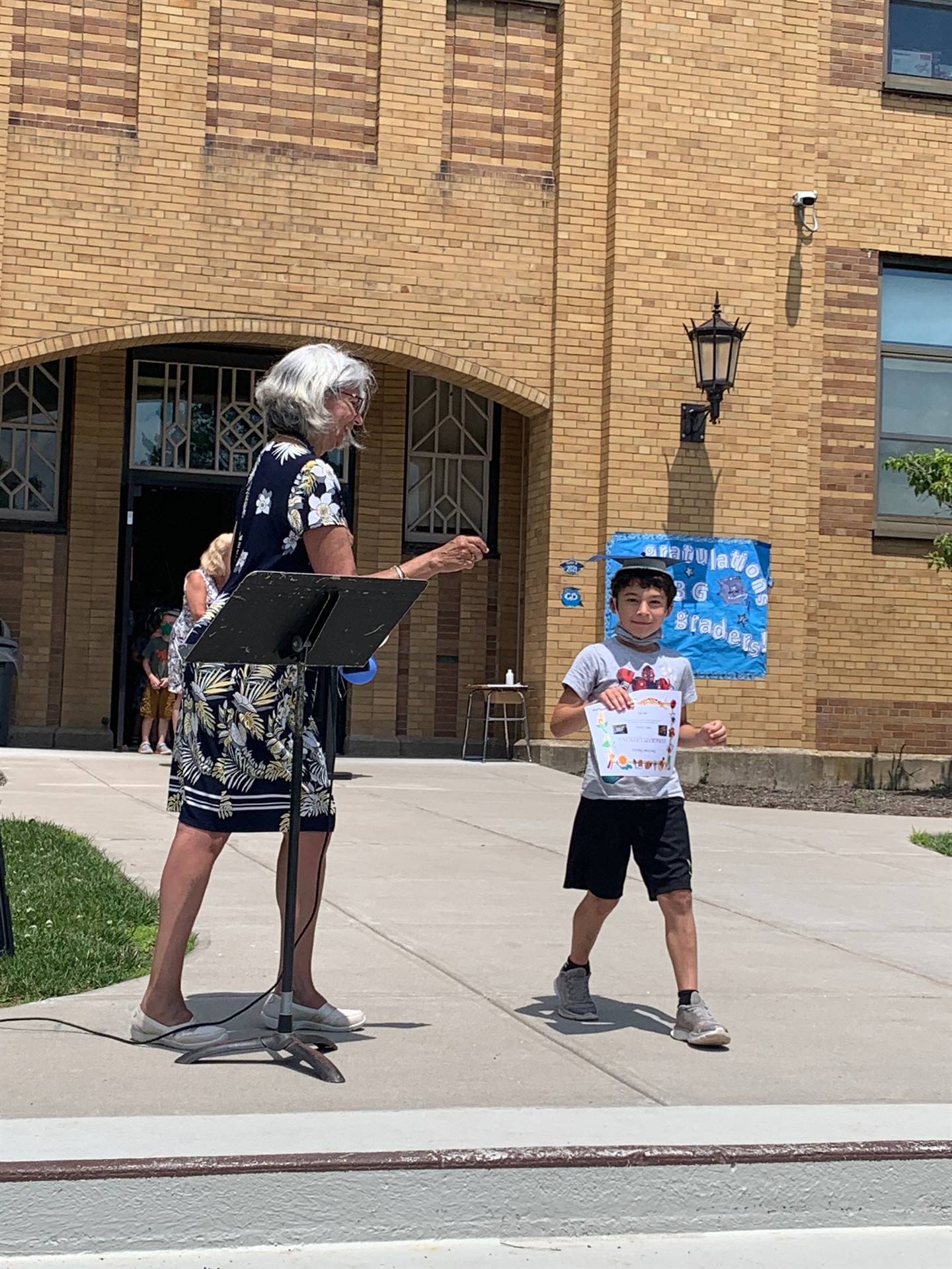 Principal hands certificate to student