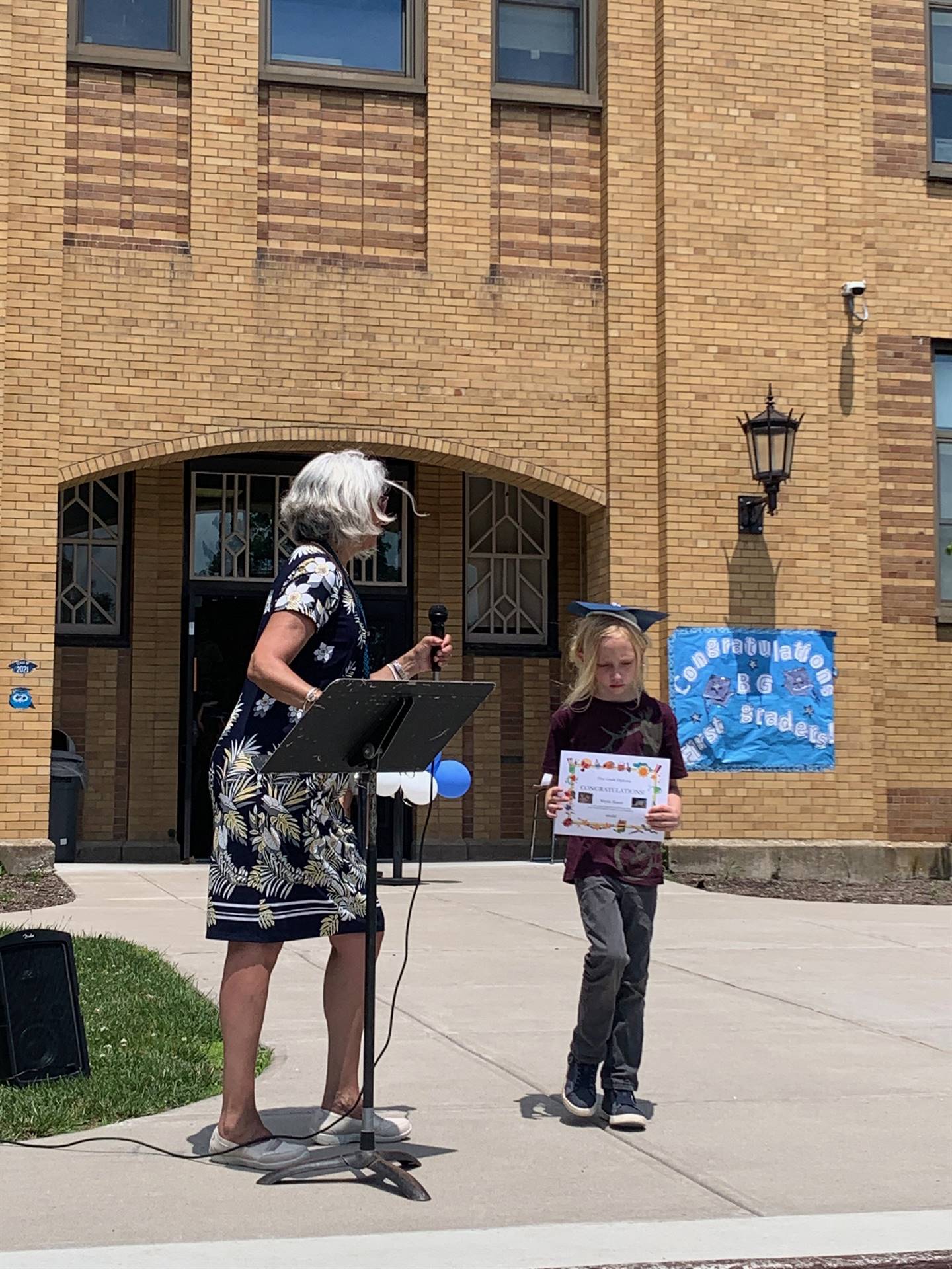 Principal hands certificate to student