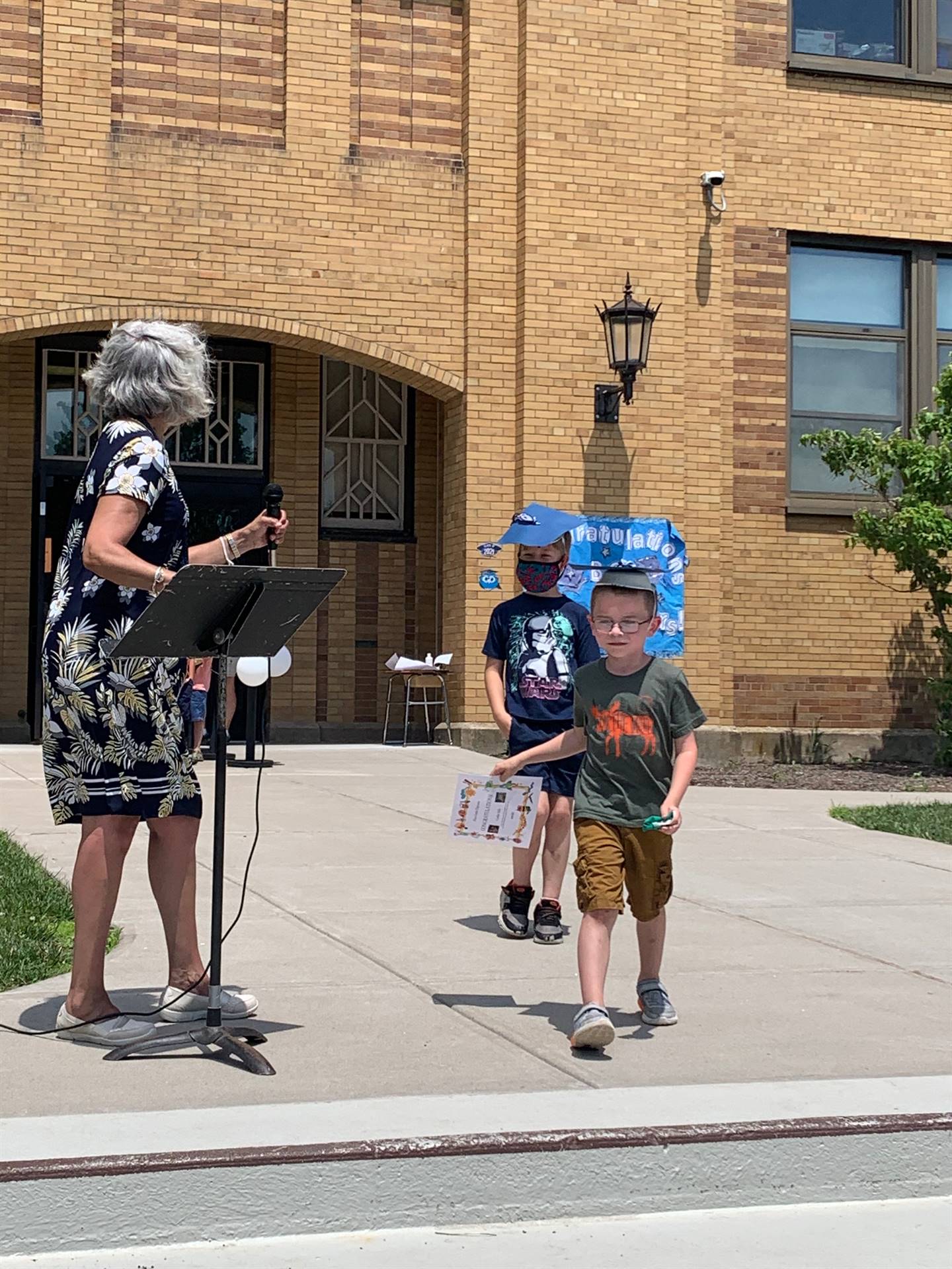 Principal hands certificate to student