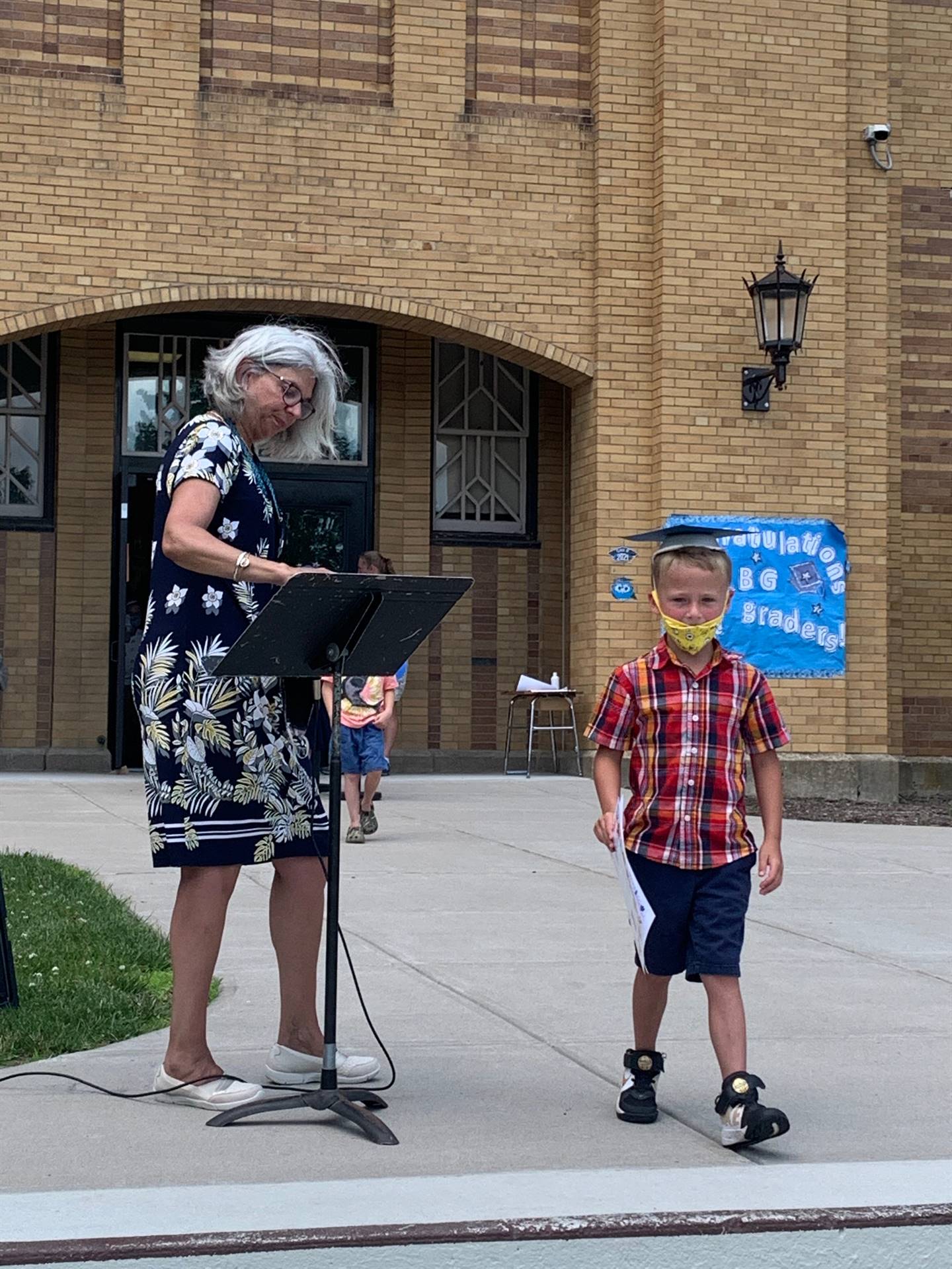 Principal hands certificate to student