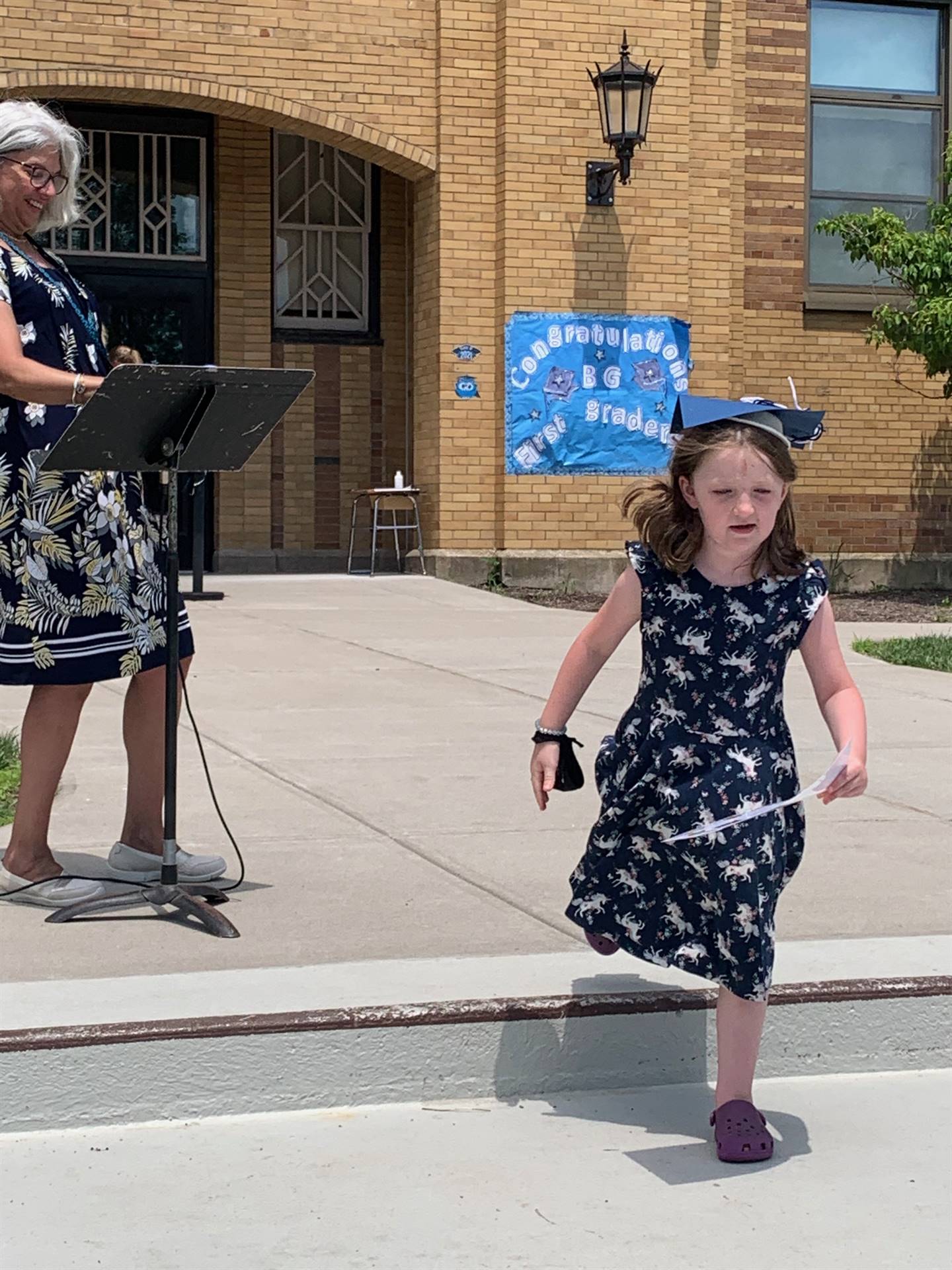 Student is walking to get certificate. 