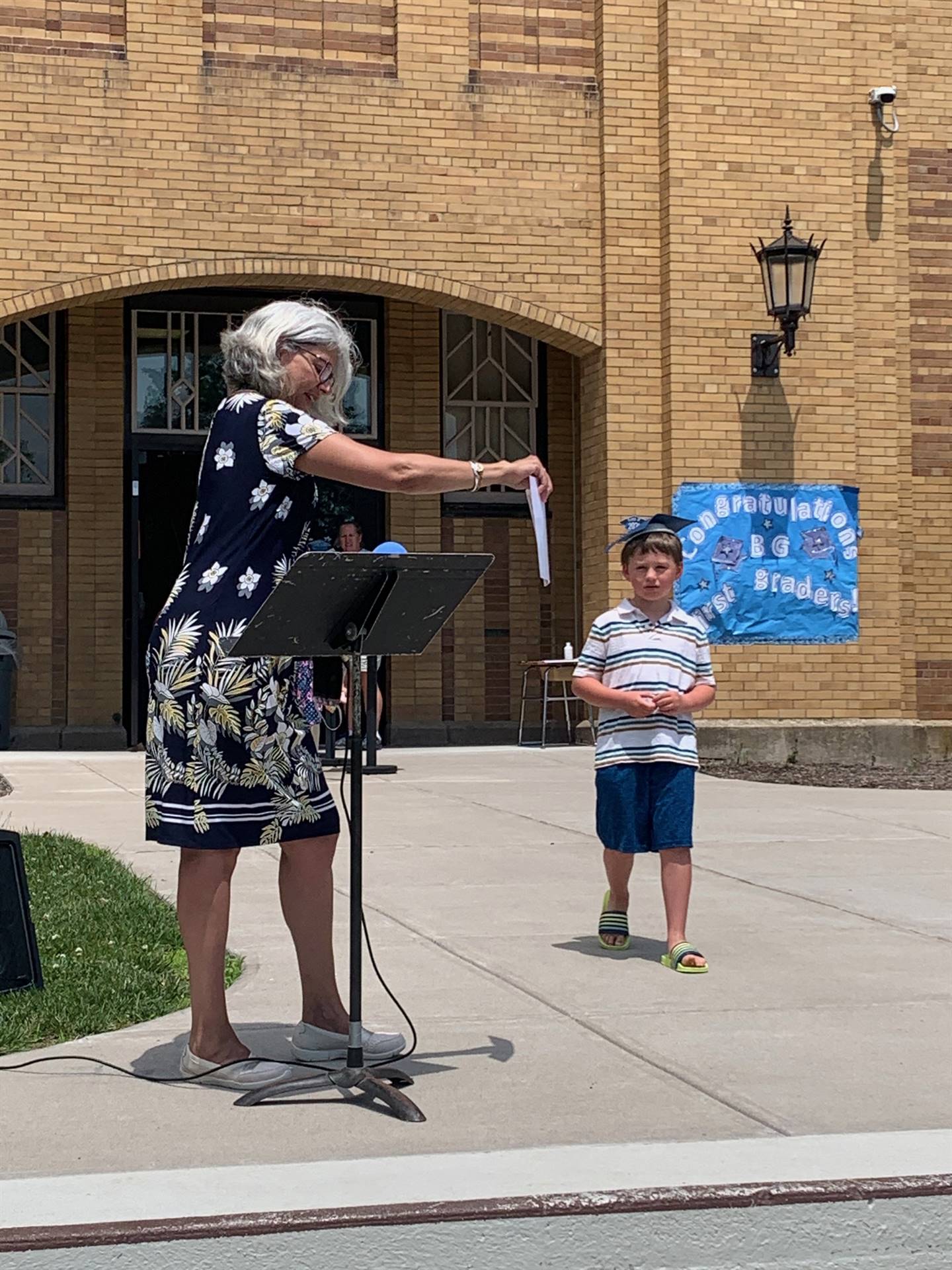 Principal hands certificate to student