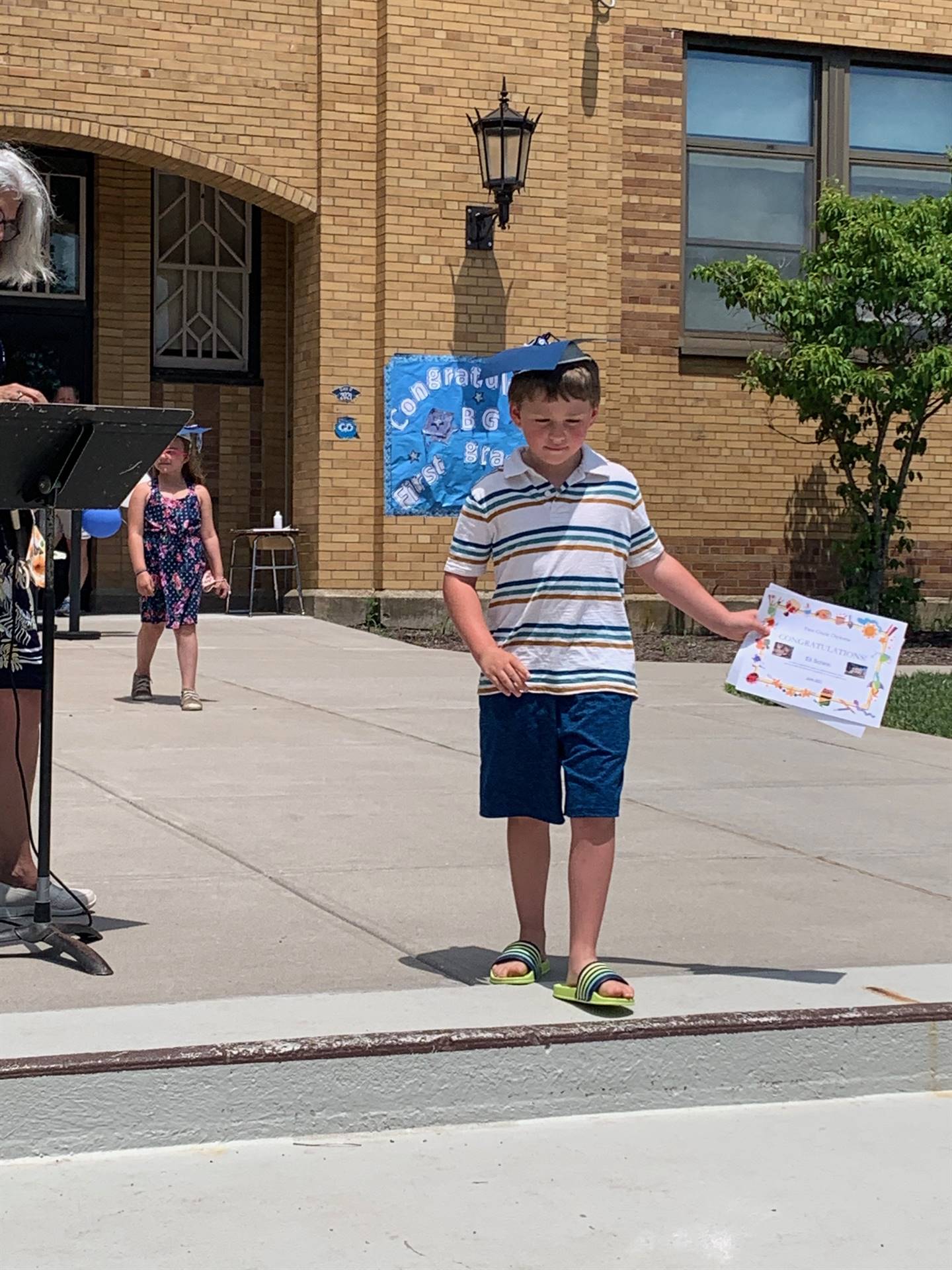 Principal hands certificate to student