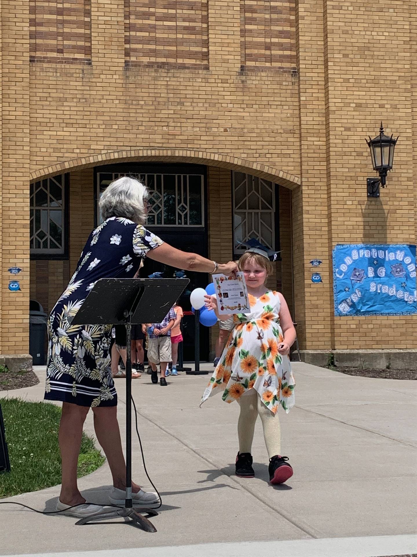 Principal hands certificate to student